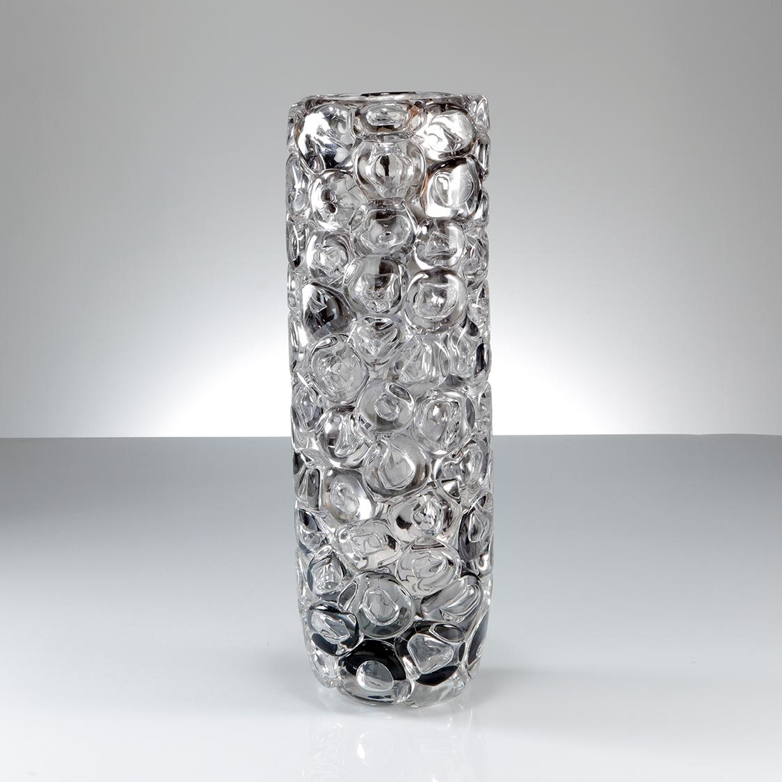 Bubblewrap in Monochrome II is a hand blown and sculpted vase created from clear and grey glass, with a mirrored interior by the British artist Allister Malcolm. Playful yet elegant, Malcolm has formed oversized bubbles on the exterior of this