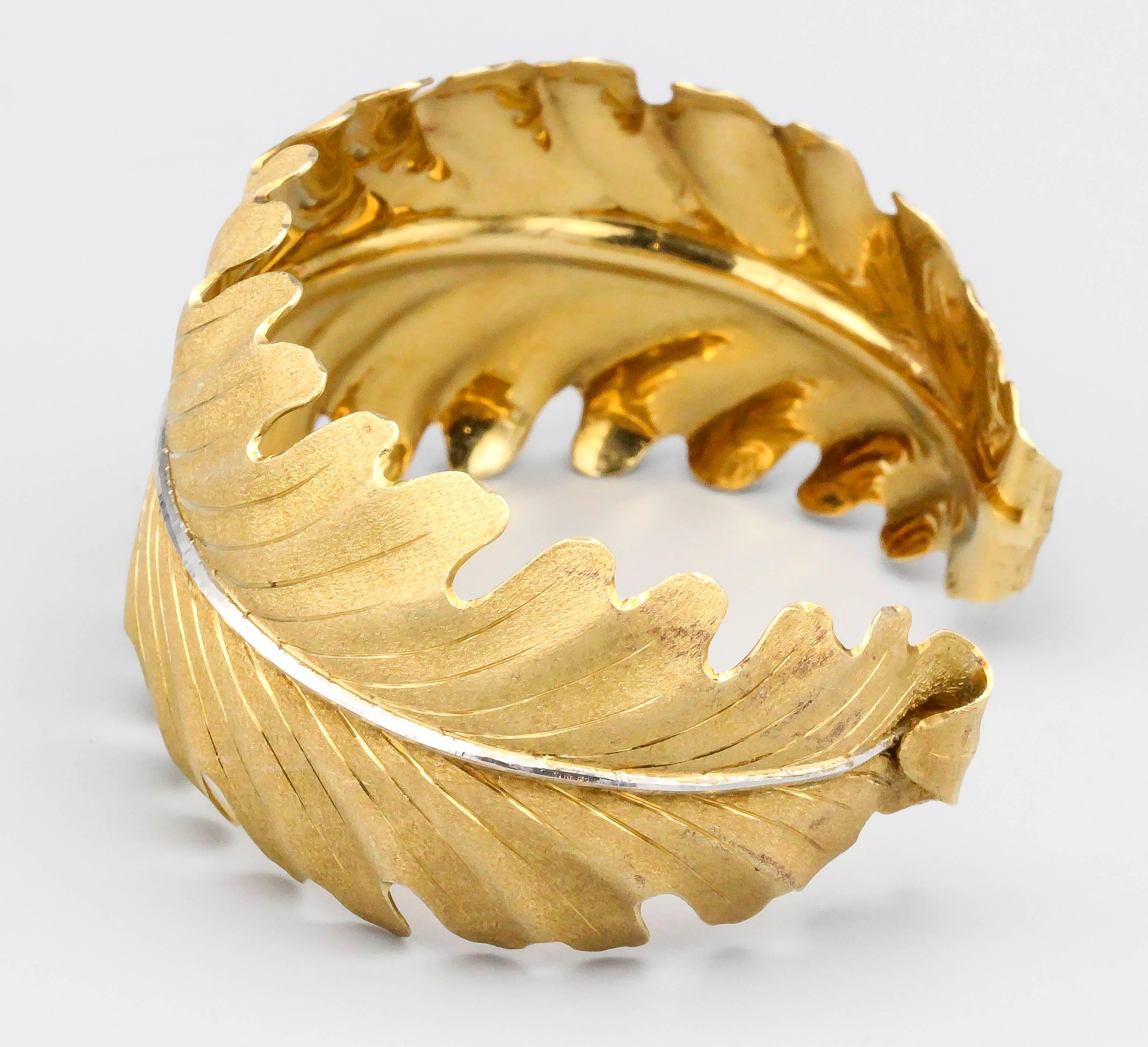 Fine 18k yellow and white gold cuff bracelet by Buccellati, circa 1970s.  The bracelet features a curved leaf design with the trademark 