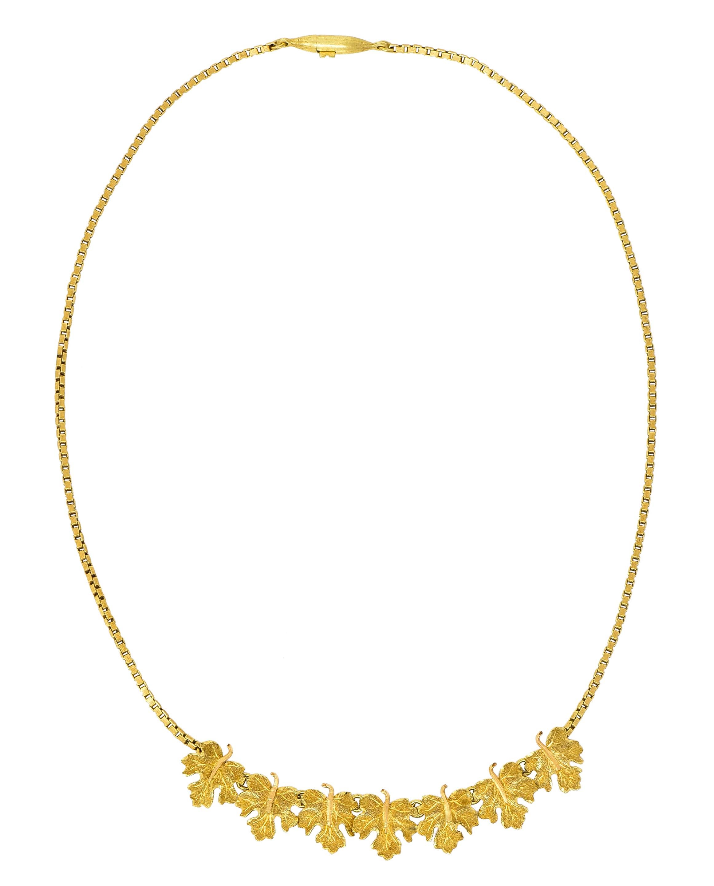 Necklace centers a station of seven highly rendered grape leaves

With fine stippled texture, delicately hand engraved veining, and rose gold stems

Connected by concealed jump rings and affixed to gold box chain completed by a barrel clasp

Fully