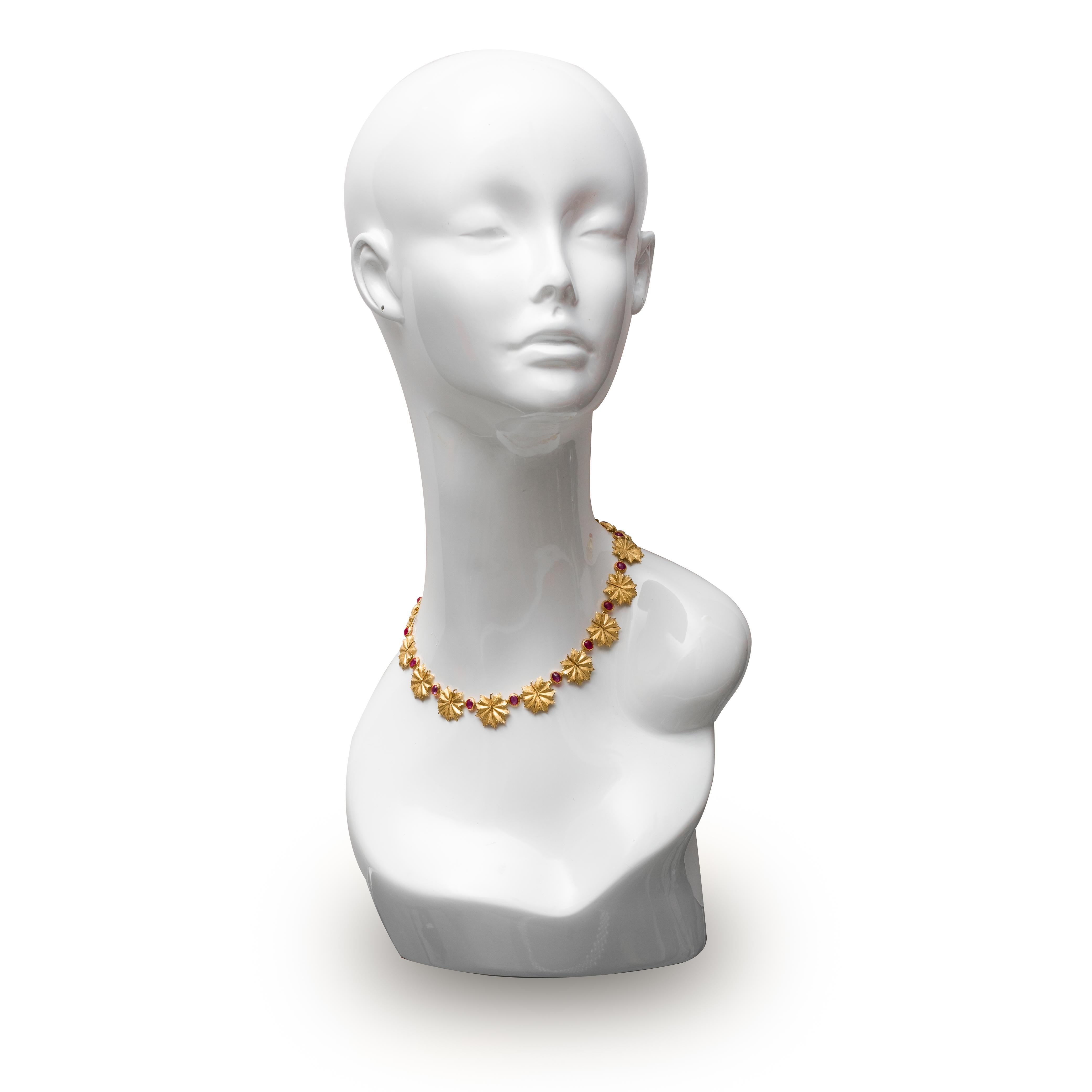 Authentic Buccellati 18 karat yellow gold leaf motif necklace set with 16 cabochon ruby stones weighing approximately 9.5 carats. Signed Buccellati, Italy 18K. The necklace is 15 1/2 inches in length. Necklace comes with original pouch. CIRCA 2010s.