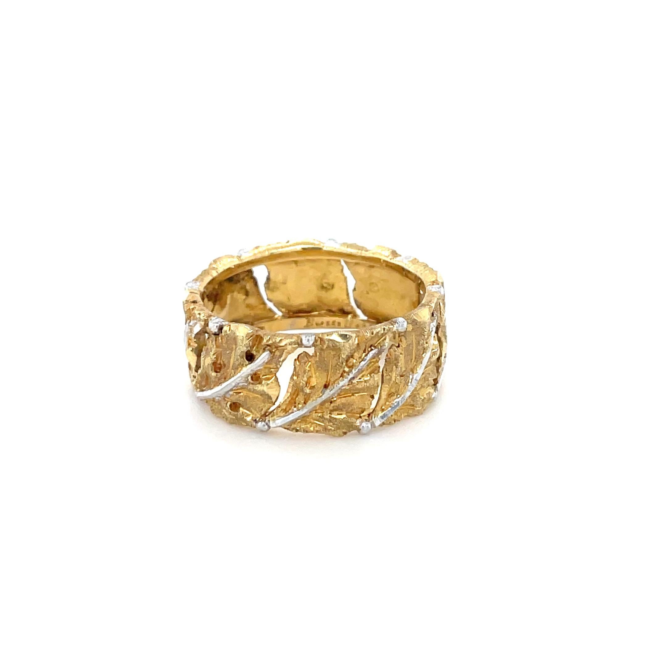 In a hand engraved openwork foliate design with gold leaves and white gold center stems in a textured finish.

Metal: 18K yellow and white gold
Engraved: Buccellati Italy 18K
Ring size: 7.50
Measurements: 3/8 inch wide
Gross weight: 6.20 grams