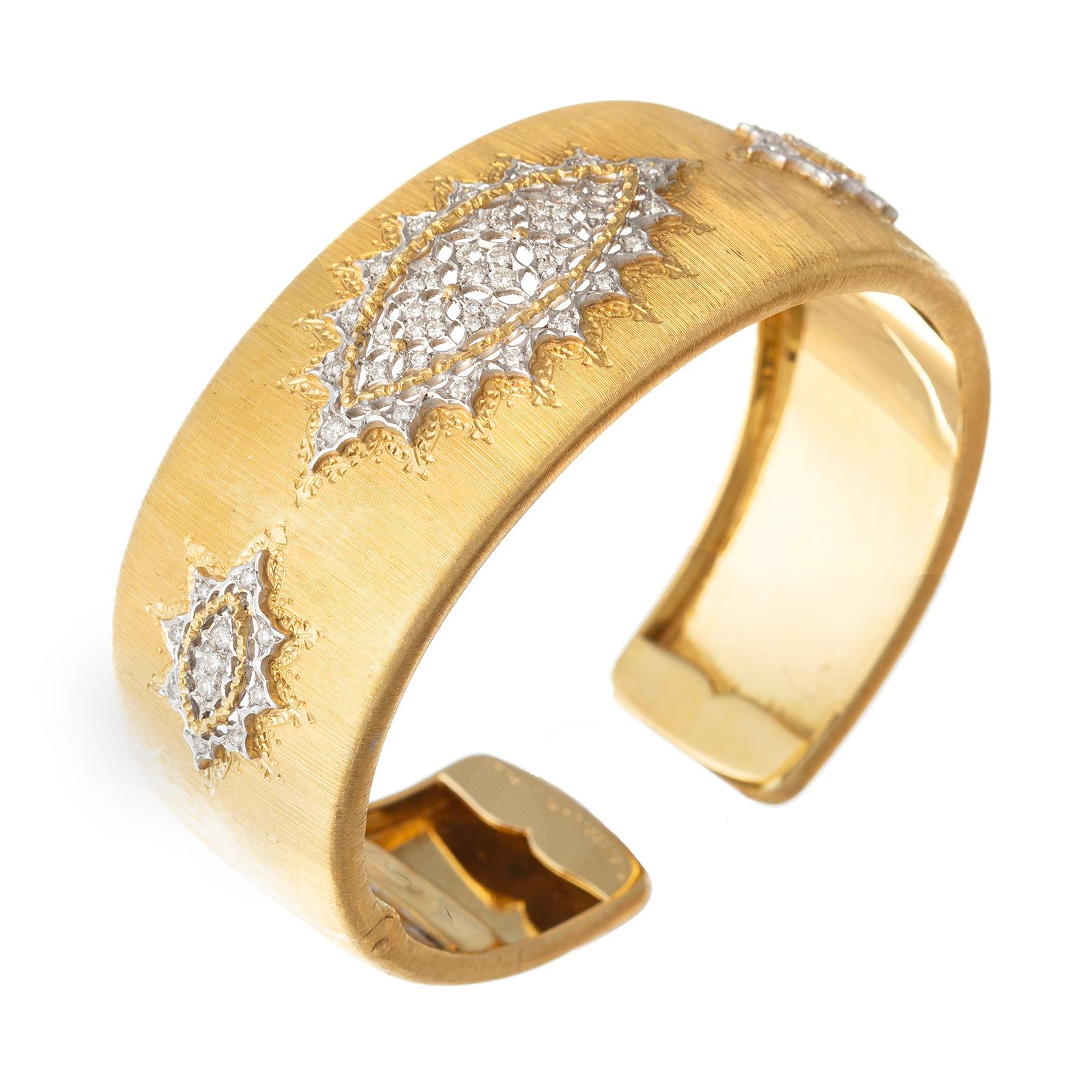 Mario Buccellati hinged cuff bracelet in 18k yellow gold, featuring Buccellati's iconic 'rigatto' engraving technique on the curved surface with three 'modellato' navette sunburst designs in 18k white gold set with 68 brilliant-cut diamonds.