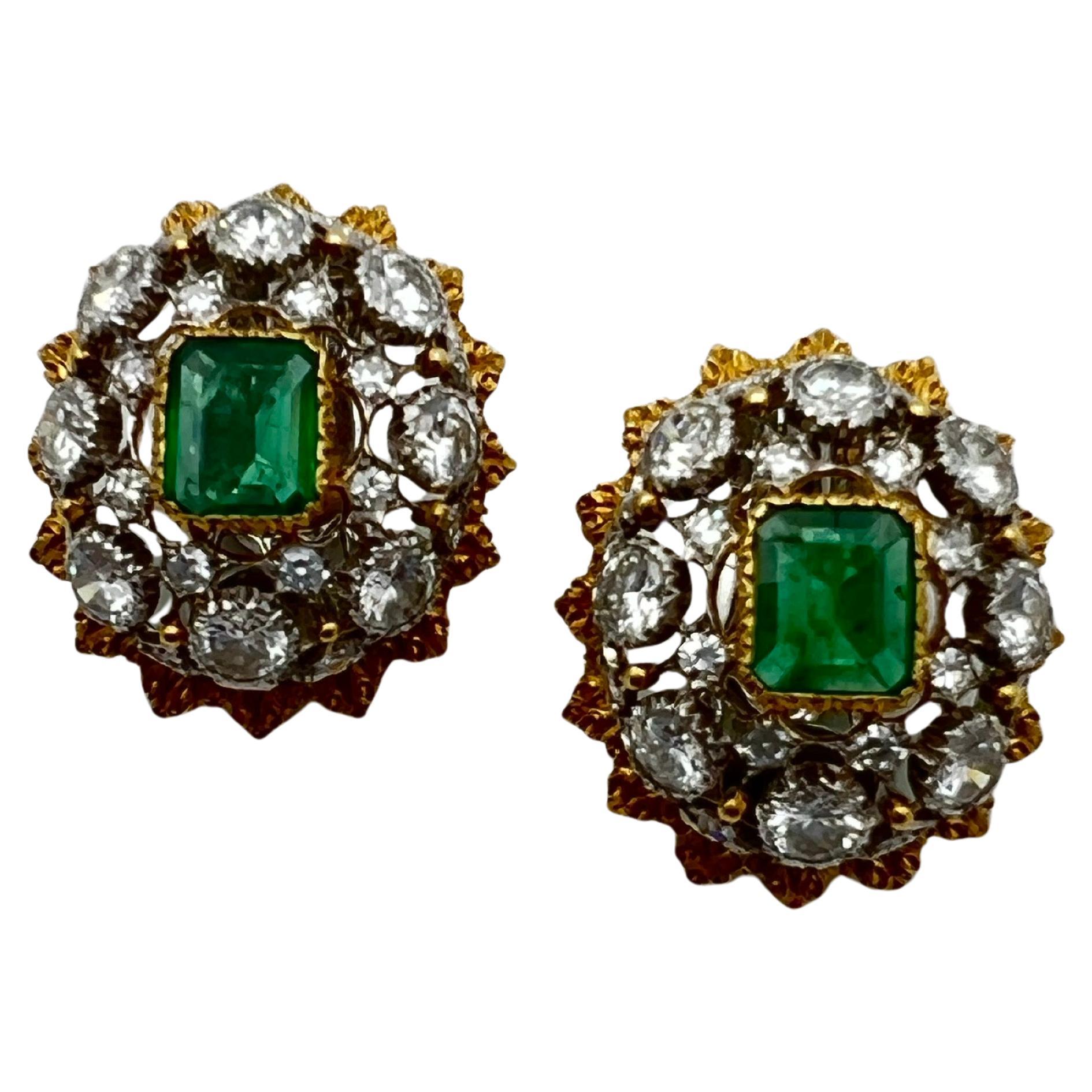 Buccellati oval-shaped domed clip earrings, each centering an 18k yellow gold bezel-set emerald-cut emerald surrounded by an openwork lattice of round-cut diamonds in 18k white gold framed by textured 18k yellow gold borders. Emeralds each measuring