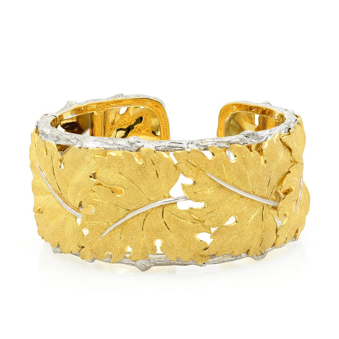 From designer Buccellati, this 18 karat white and yellow gold cuff bracelet is made up of textured yellow gold leaf motifs bordered by white gold bark edges. The cuff is hinged and measures 68x32mm.
-	18k White & Yellow Gold
-	Textured