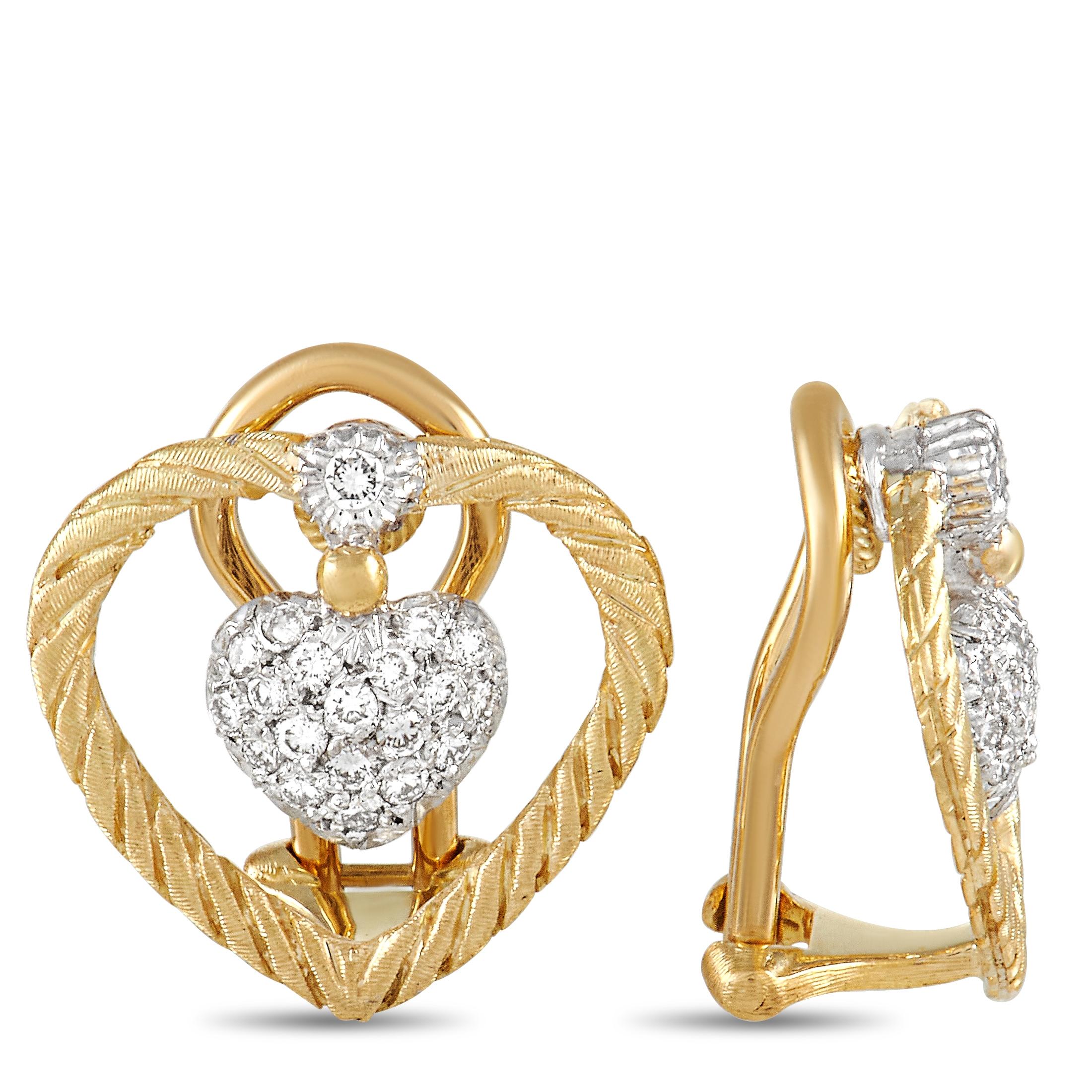 These sweet Buccelatti earrings add the perfect touch of sparkle to any outfit. The earrings are made with 18K yellow gold, forming an openwork heart with a smaller heart charm set in the center of each. The inner heart is set with a cluster of