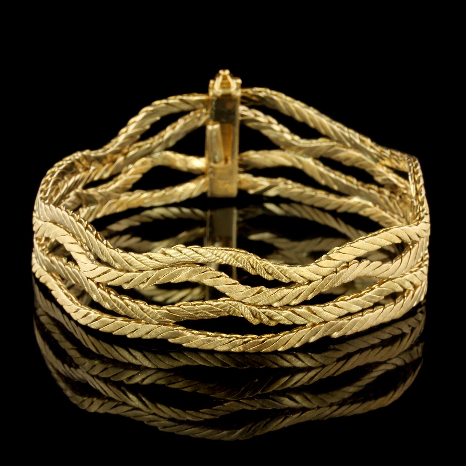 Buccellati 18K Yellow Gold Bracelet. The bracelet is designed with four rows of
flexible hand engraved links, length 7 1/2