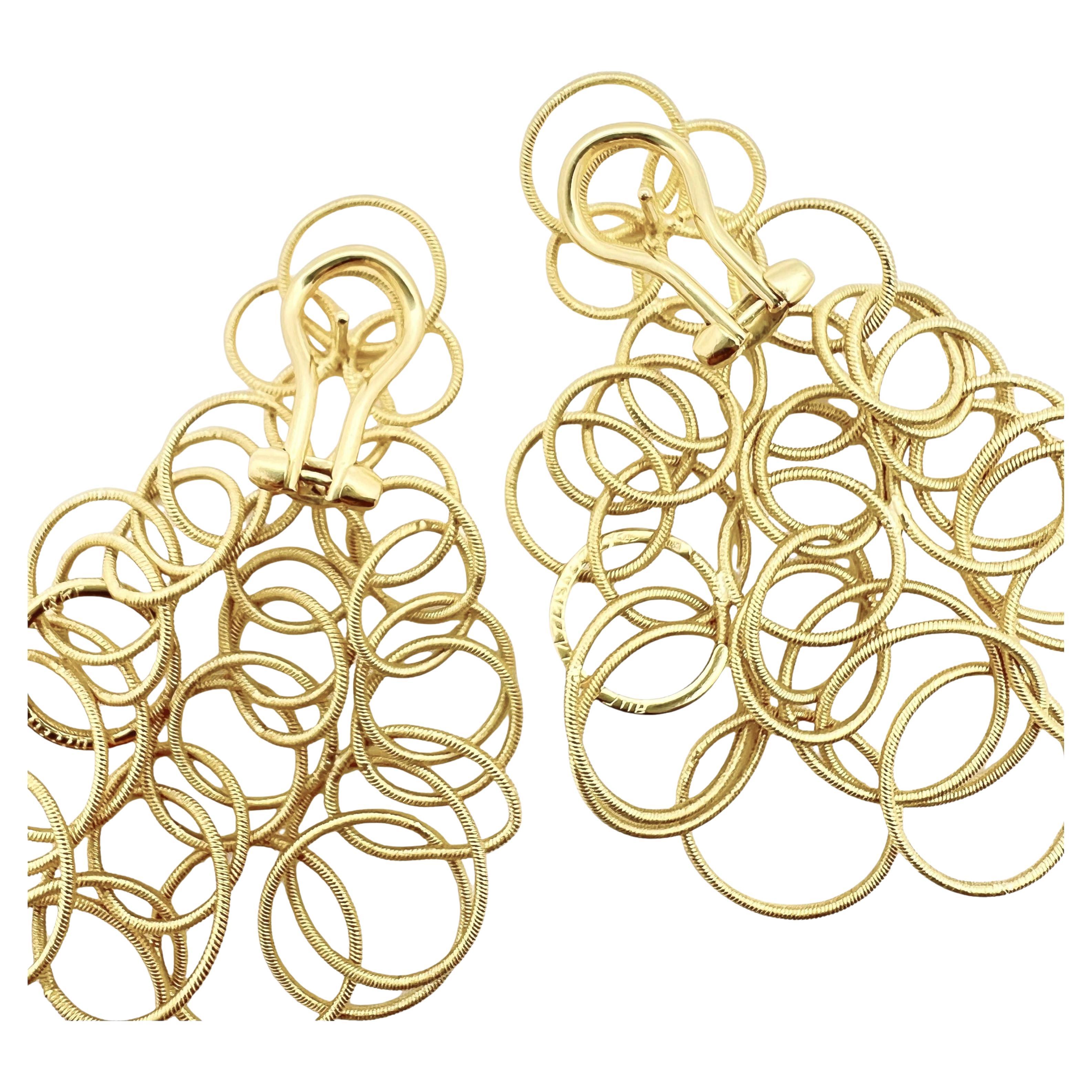 The medium size 'Hawaii' earrings by Buccellati in 18k karat yellow gold, composed of interlocking, 18k yellow gold circles of graduated size. Measuring approximately 2.5