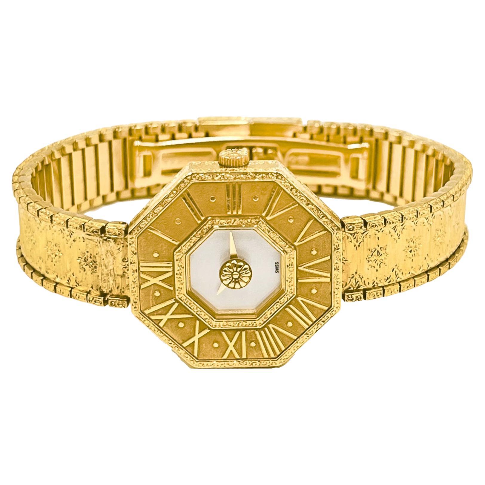 Designed by Gianmaria Buccellati, this 18k yellow gold Oktachron bracelet wristwatch features an octagonal 26mm case with Roman numeral-delineated bezel and mother-of-pearl dial. The band is engraved in Buccellati's signature 'rigato' style which