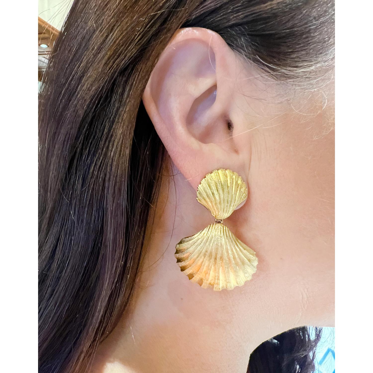 Unique shell door knocker design earrings by Mario Buccellati.  This classic shell motif design is comprised of a smaller shell with larger inverted shell drop bottom.  Hand finished in the Buccellati engraving style with a recessed stripe design on