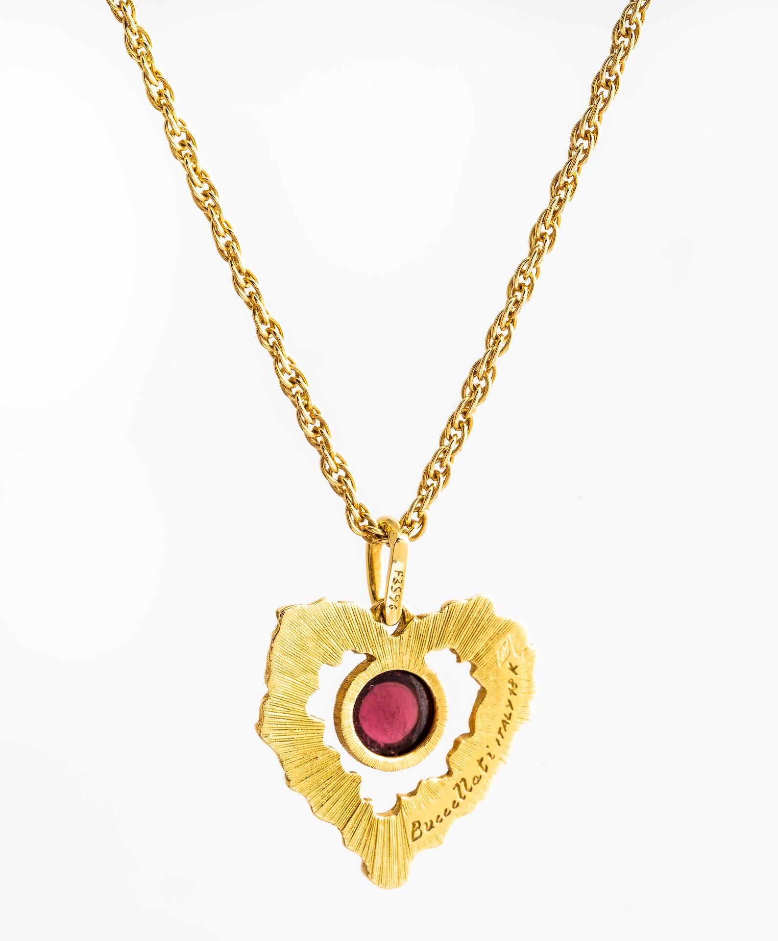 Vintage Buccellati 18K yellow gold textured heart pendant set with a rubelite on 18ky rope chain.  Cabochon measures 6mm and is bezel set in 18KY gold surrounded by gold heart leaf design.  Heart pendant measures 20mm.  Rope chain is 2mm in width