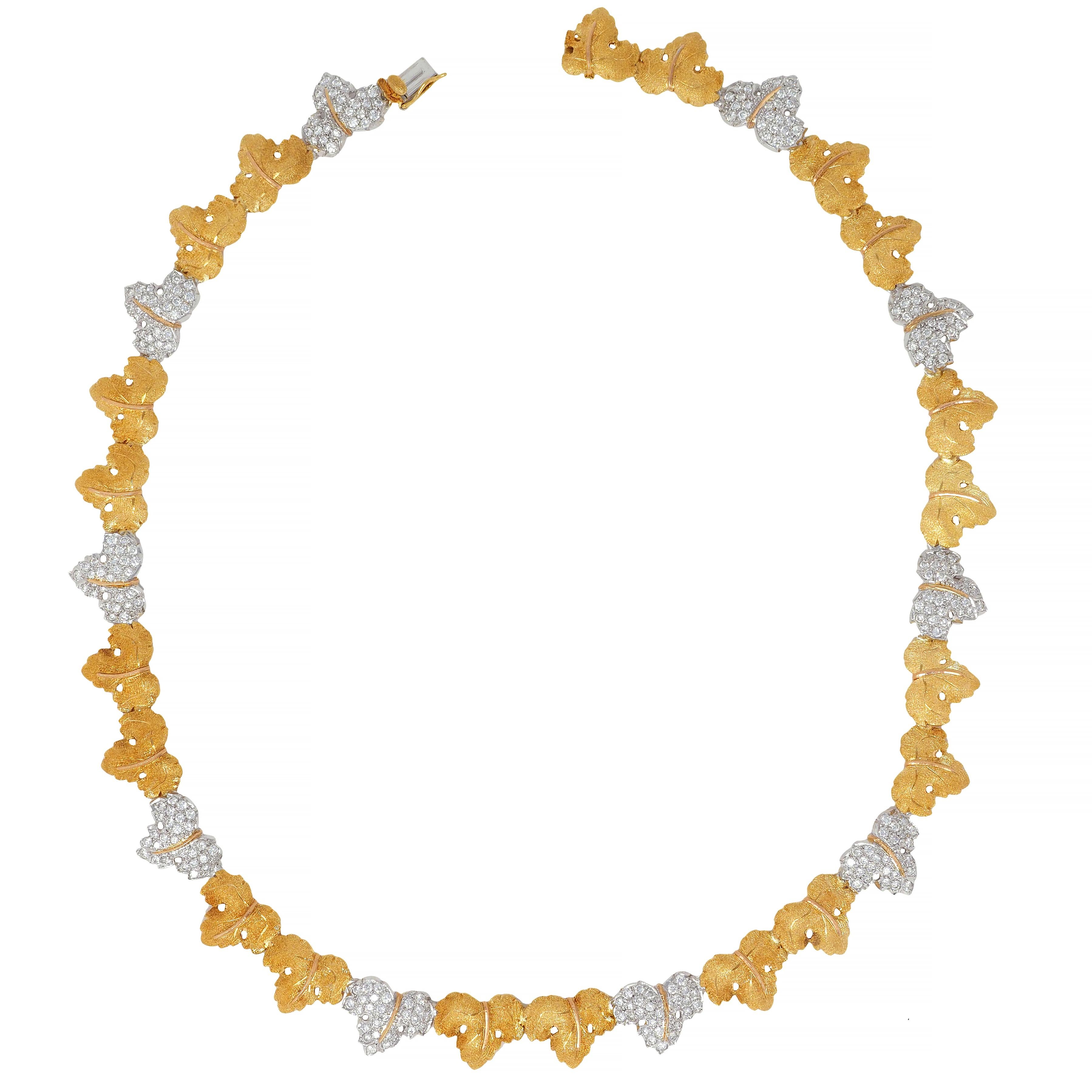 Designed as a garland of grape leaves alternating with white and yellow gold
Featuring round brilliant cut diamonds bead set in white gold leaves
Weighing approximately 4.50 carats total - G/H in color with VS2 clarity
With fine segrinato texture
