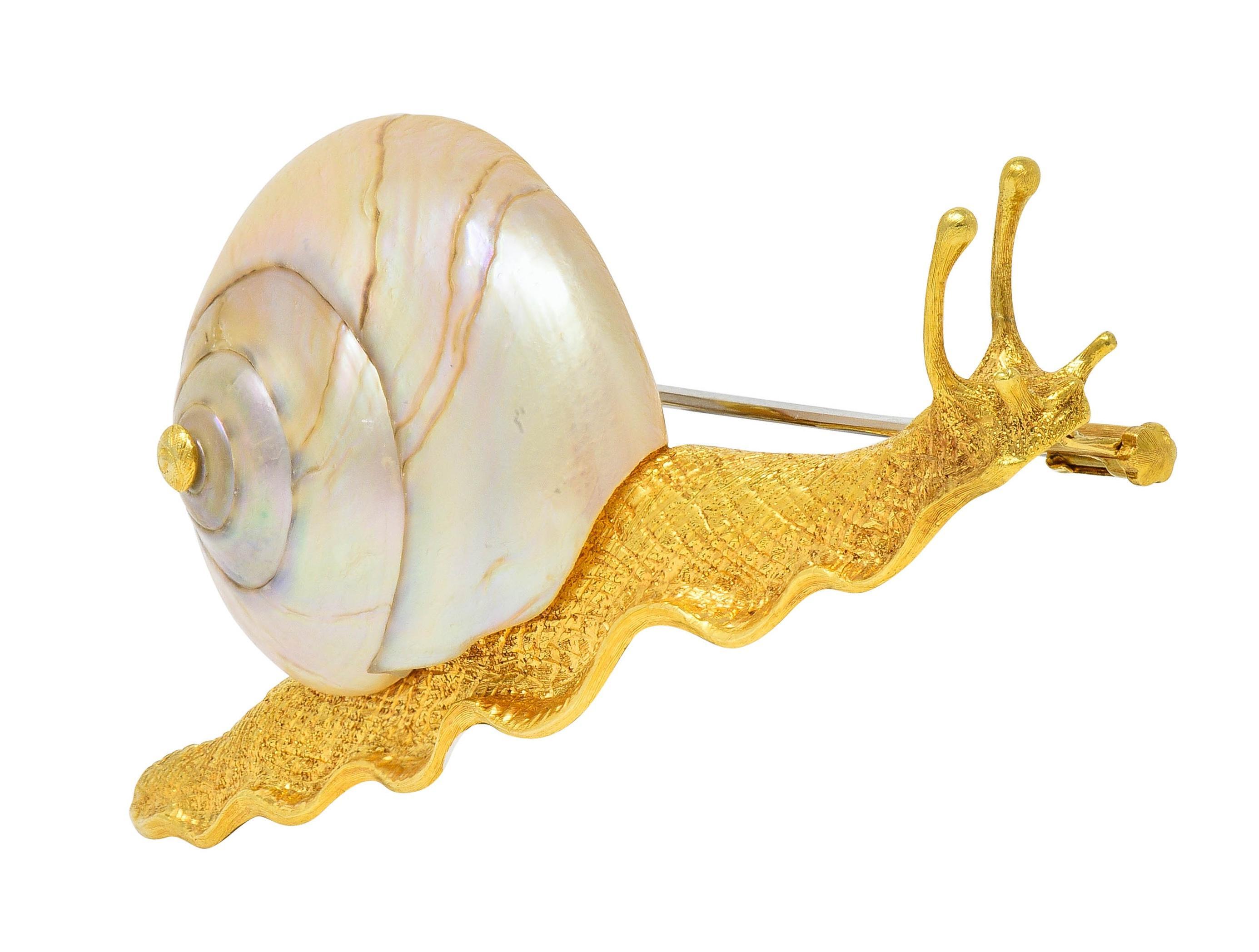 Designed as a stylized snail with dimensional features and crosshatch texture throughout
Featuring a carved and swirling mother-of-pearl shell - translucent white
Displaying very strong iridescence with veining throughout
Completed by hinged pinstem