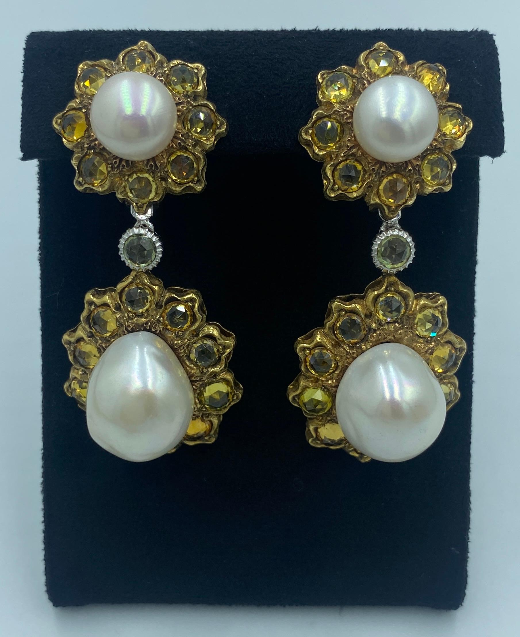 These stunning 18 carat gold earrings designed by Gianmaria Buccellati in 1980s consist of 2 floral links. each flower has a large pearl in its centre and various shades of yellow sapphires as its petals. The 2 flowers on each earring are linked