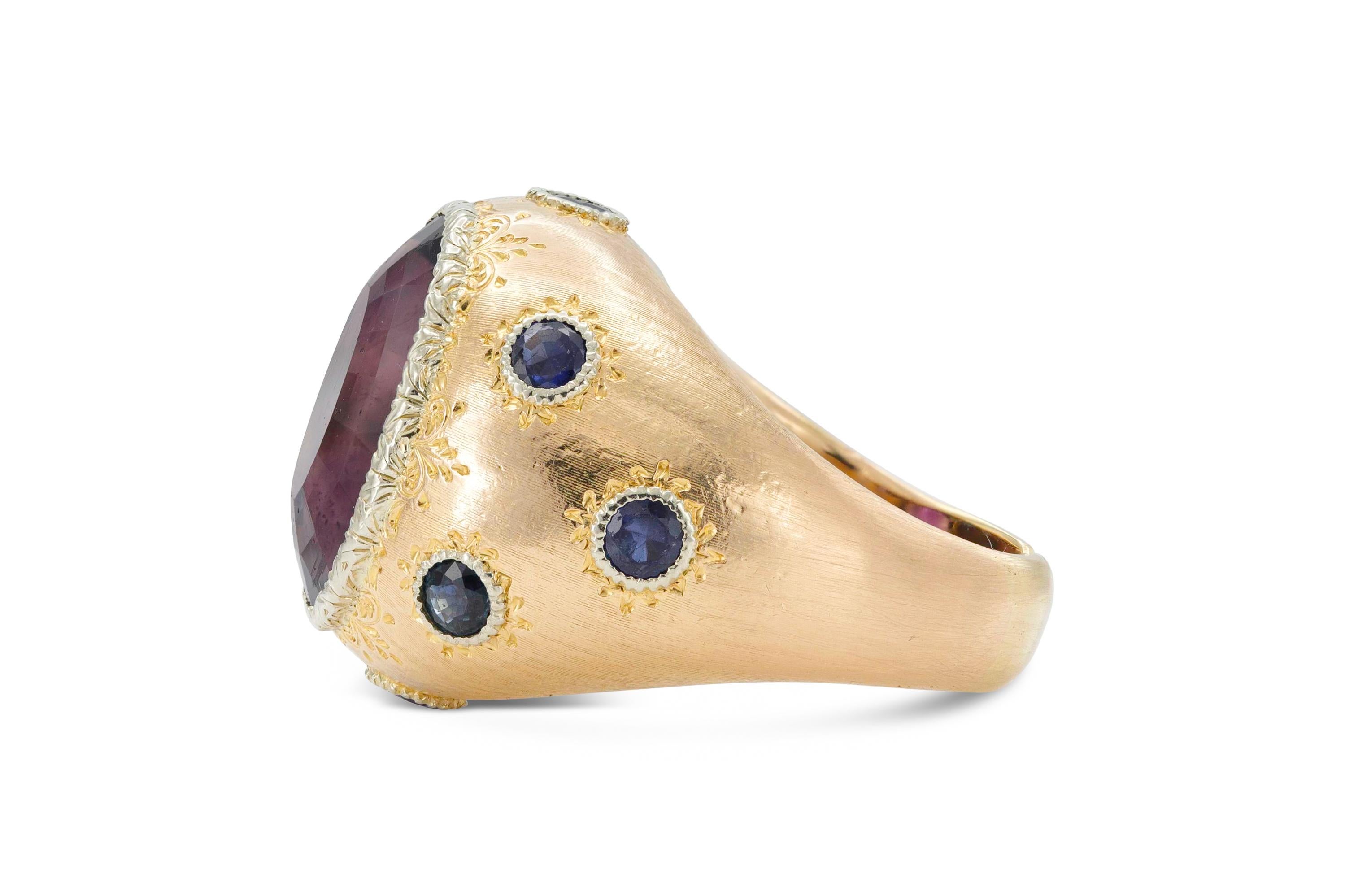 Finely crafted in 18K yellow gold with a center amethyst stone and surrounding sapphires.
Size 6 3/4.
Signed by Buccellati.