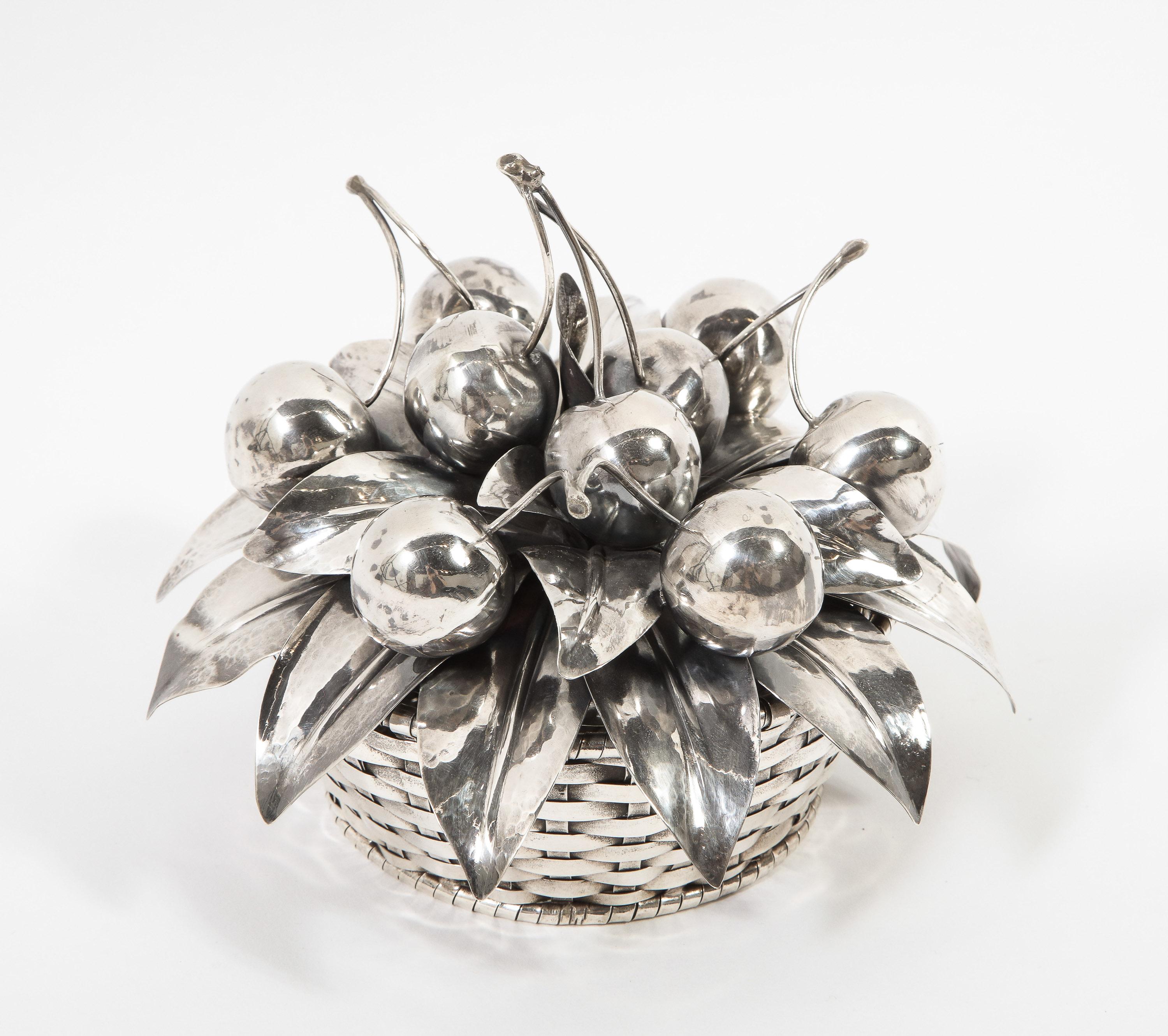 Buccellati, an Italian sterling silver cherry fruit basket bowl and cover, circa 20th century.

With 9 silver cherries. Woven silver basket form. 

Signed Buccellati Italy Sterling. 100% authentic guaranteed.

Weighs 468 grams.

Measures: