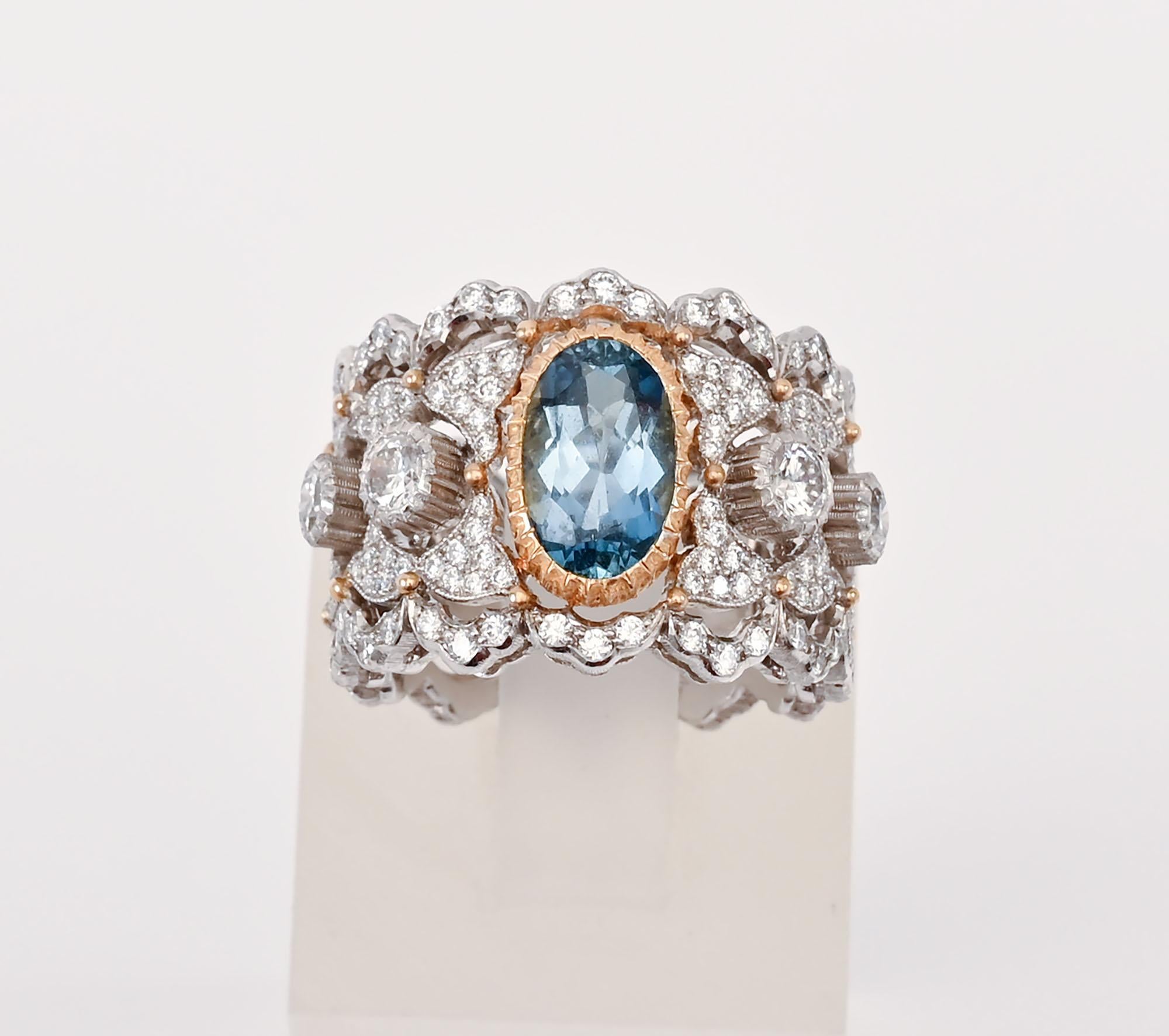 Exquisite diamond band ring by Buccellati with a central aquamarine that weighs approximately 2 carats. The ring is 18 karat white gold and platinum with the exception of the yellow gold ribbed bezel around the aquamarine. The ring has 94 diamonds.