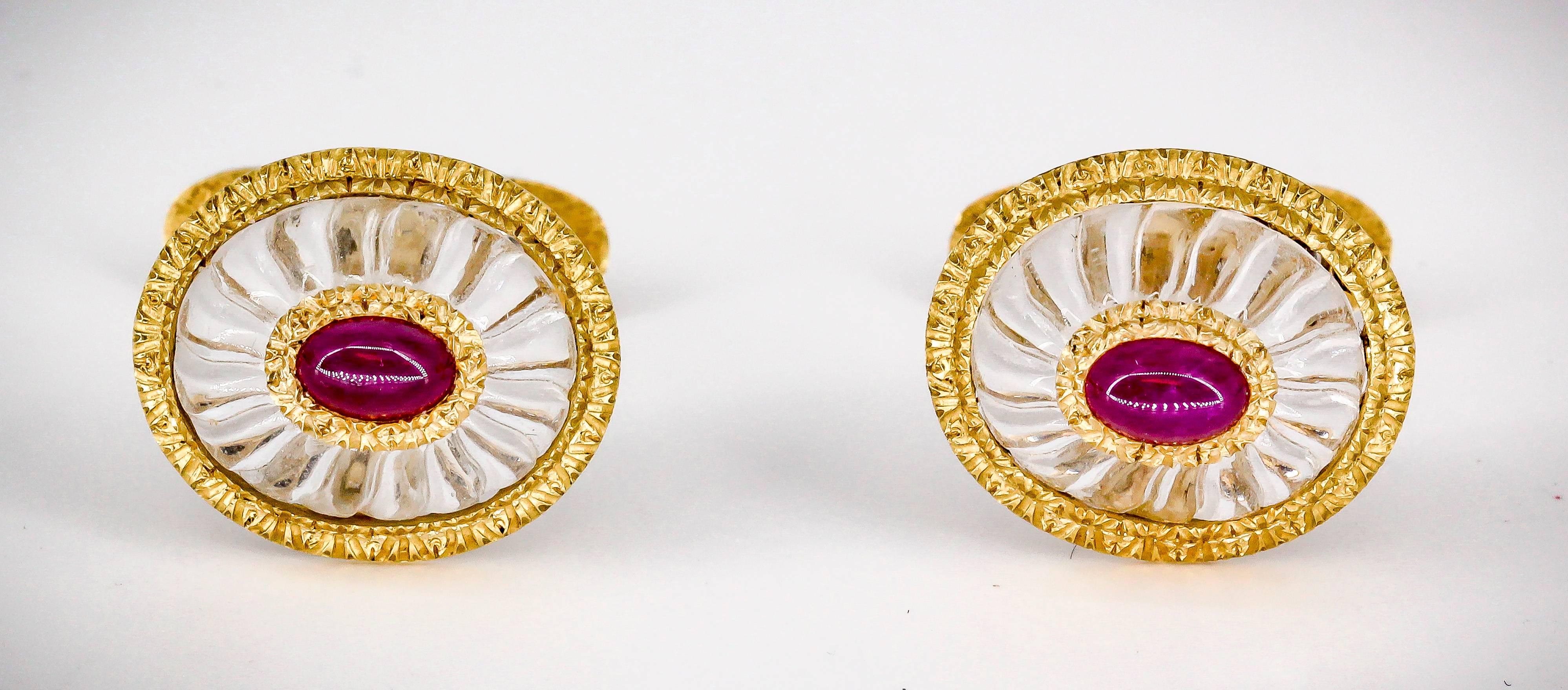 Handsome and refined cabochon ruby, rock crystal and 18K yellow gold cufflinks by Buccellati. They feature a rich red cabochon ruby in the middle, surrounded by a gold ring and rock crystal below it. The gold is detailed in the trademark Buccellati