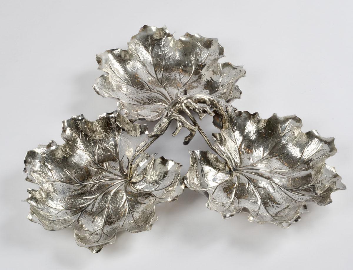 Large sterling silver centerpiece created by the famous Italian silversmith Gianmaria Buccellati.
The centerpiece is circular and composed of three finely silver chiseled grapevine leaves held in the center together. This centerpiece is nice to use