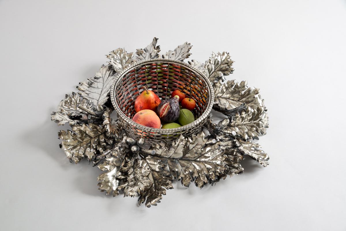 Beautiful large sterling silver centerpiece created by the famous Italian silversmith Federico Buccellati.
This circular centerpiece is quite unusual, composed of a sterling wicker style basket, removable from a large wreath of oak leaves finely