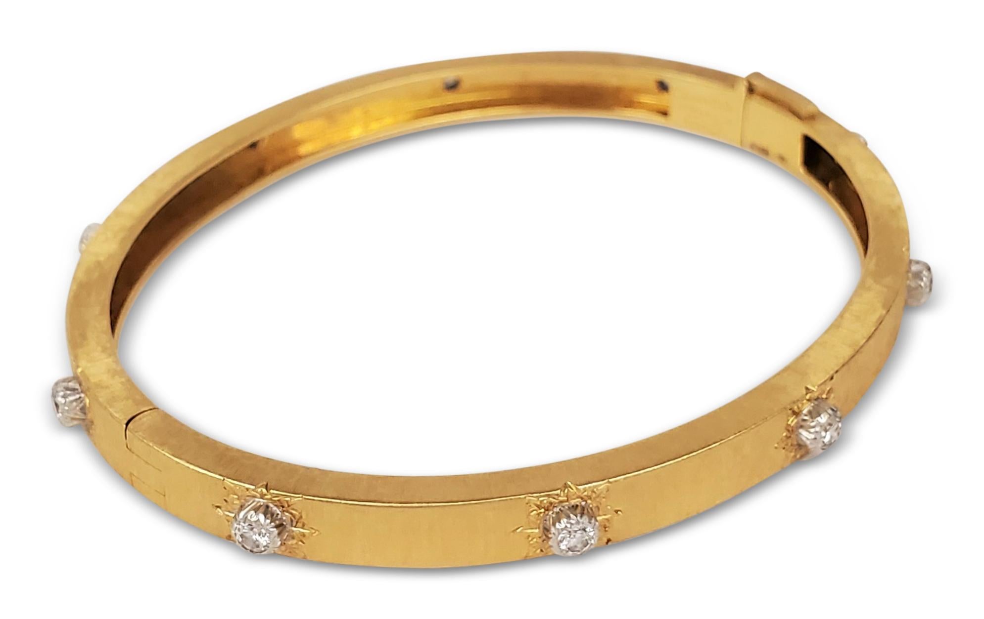 Authentic Buccellati 'Classica' bangle from the Macri collection is made in hand-engraved 18 karat yellow and white gold. The bracelet is set with 10 diamond stations of an estimated 0.48 cttw of round brilliant cut diamonds (E-F color, VS clarity).