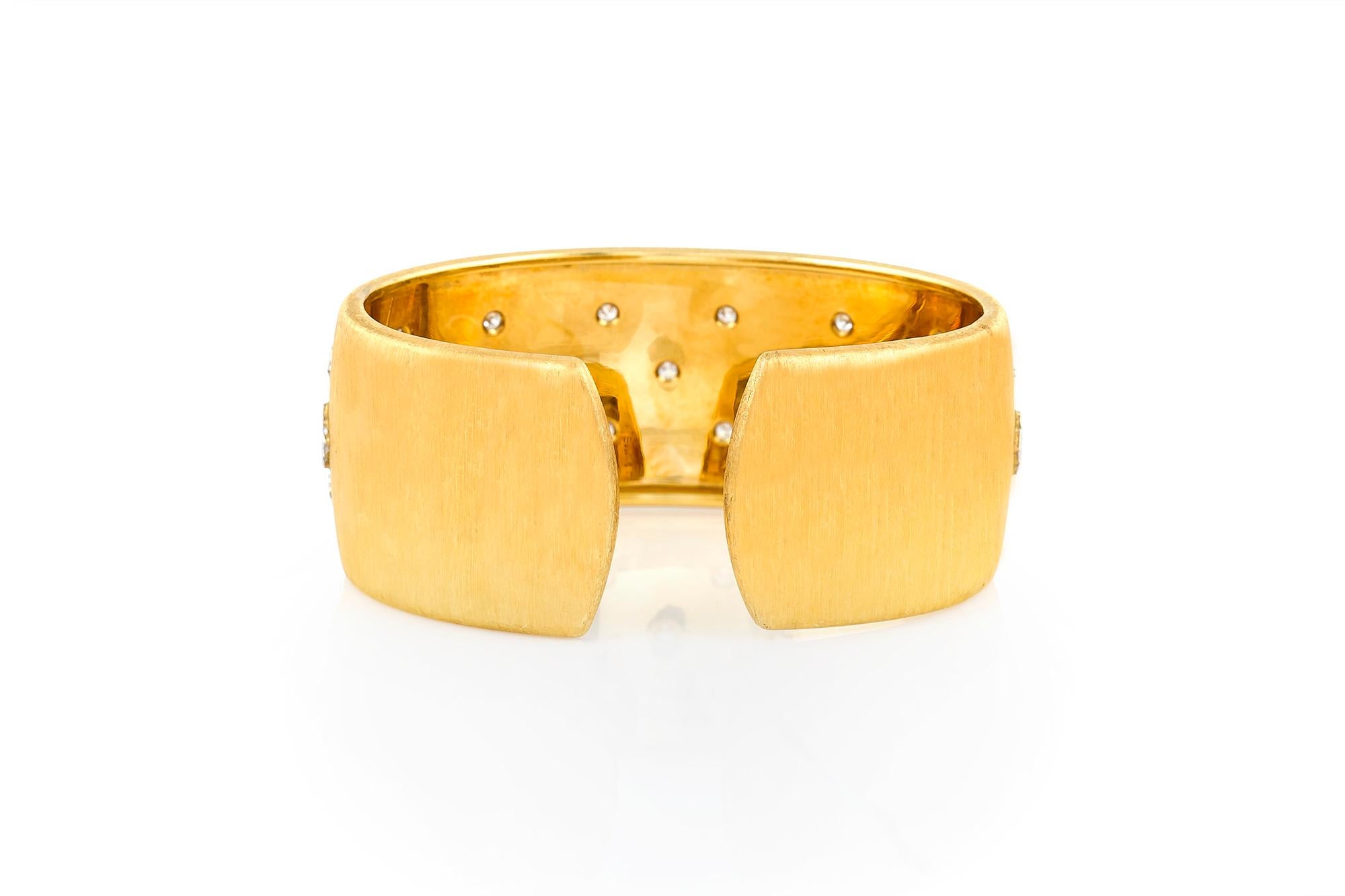 Cuff bracelet signed by Buccellati, finely crafted in 18k yellow gold with round brillaint diamonds.  