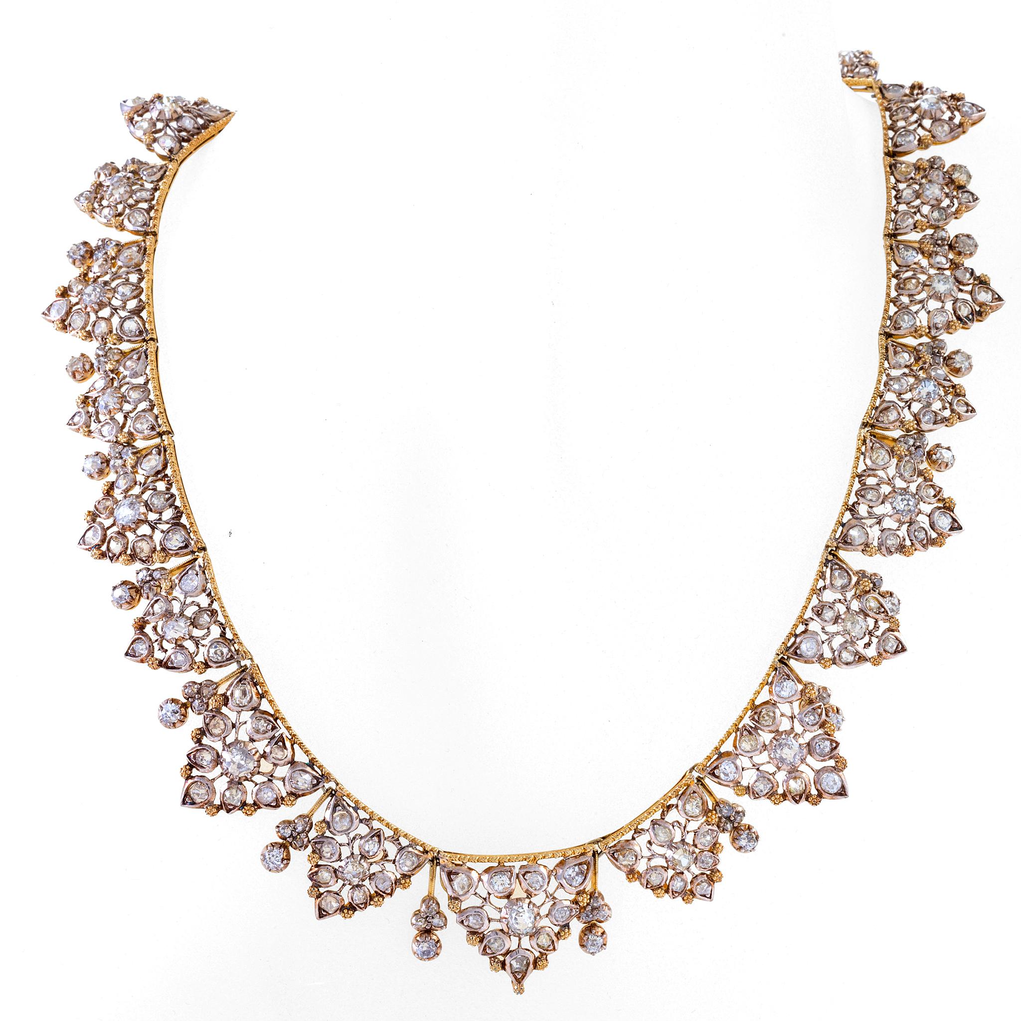 A very fine example of Buccellati’s mid-century jewels, this slightly tapered bi-color gold and diamond leaf necklace is set with nearly three hundred diamonds, weighing almost twenty carats in total. Subtly referencing classical forms, the abstract