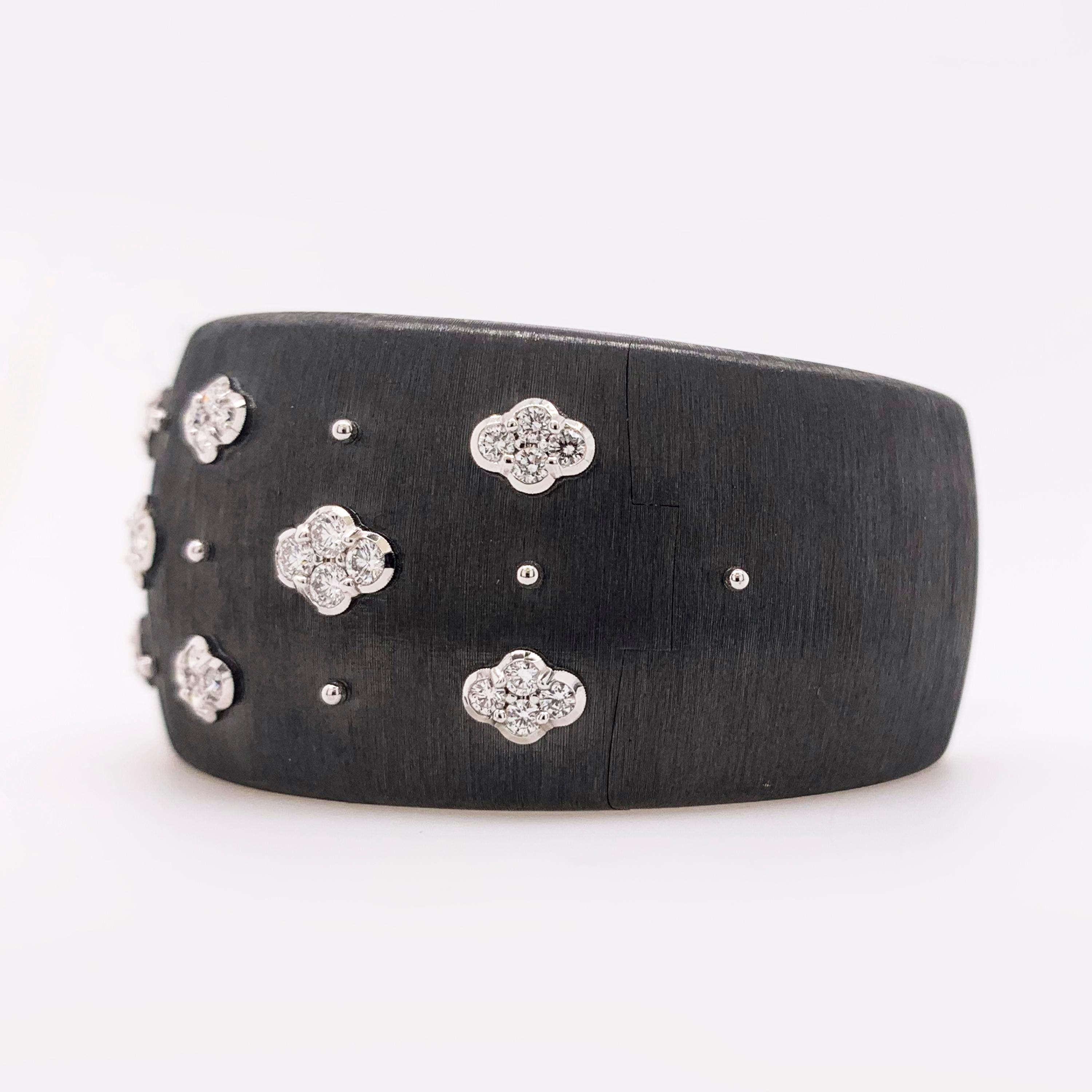 Buccellati Diamond Macri AB cuff bracelet in 18k black gold with 18k white gold accents, accompanied by Buccellati pouch.

This black gold cuff bracelet features a brushed textured finish as well as approximately 1.18 carat of round brilliant cut