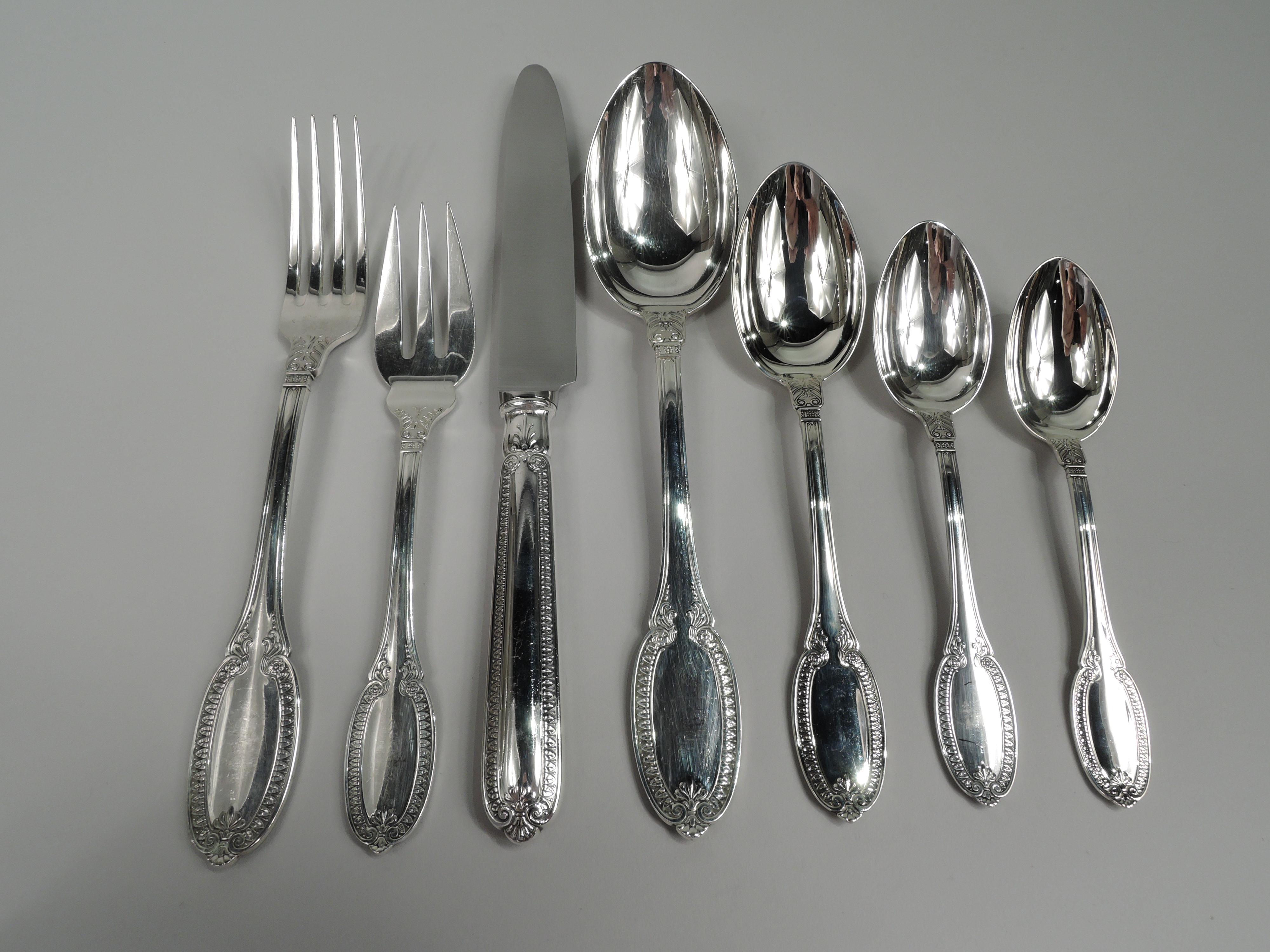 Empire sterling silver dinner set. Made by Buccellati in Italy. This set comprises 82 pieces (dimensions in inches): Forks: 12 dinner forks (8 1/4) and 12 salad forks (7); Spoons: 12 soup spoons (8 1/2), 12 dessert spoons (7), 12 teaspoons (5 5/8),