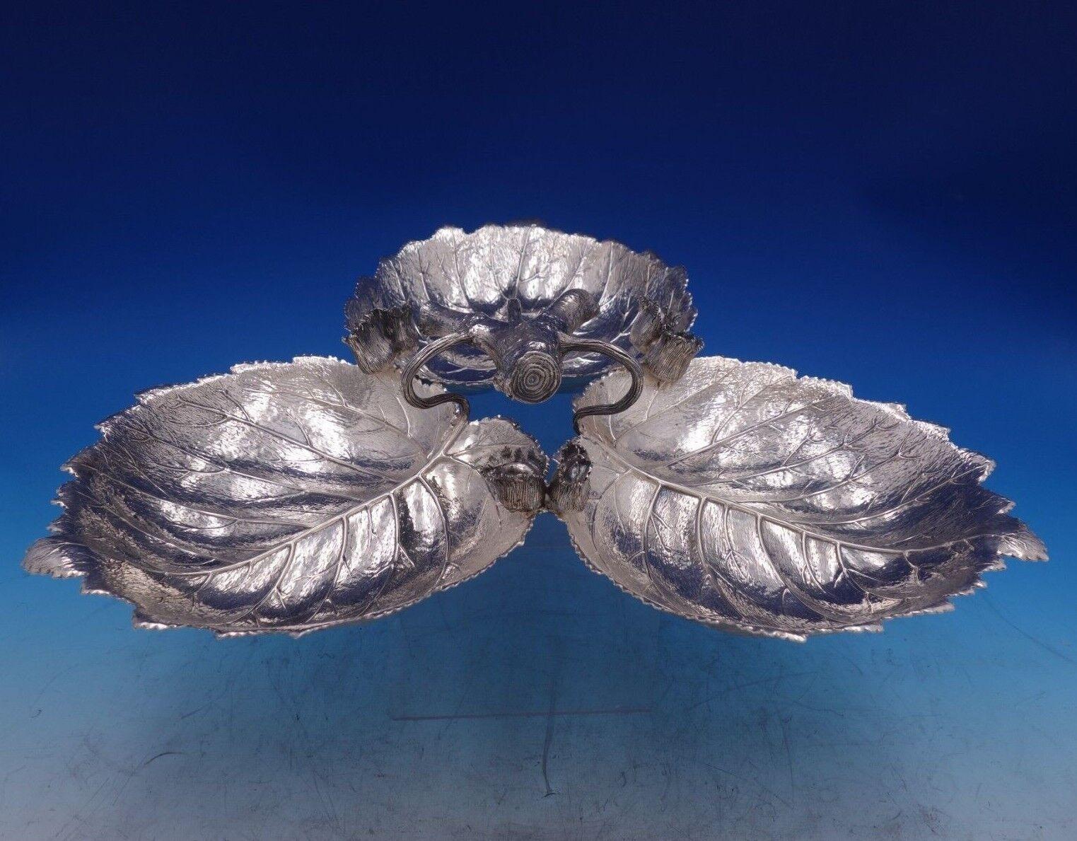 Buccellati

Captivating Gianmaria Buccellati sterling silver serving tray in the form of a triple leaf jagged featuring a branch handle and blossoms. This tray measures 3 1/2