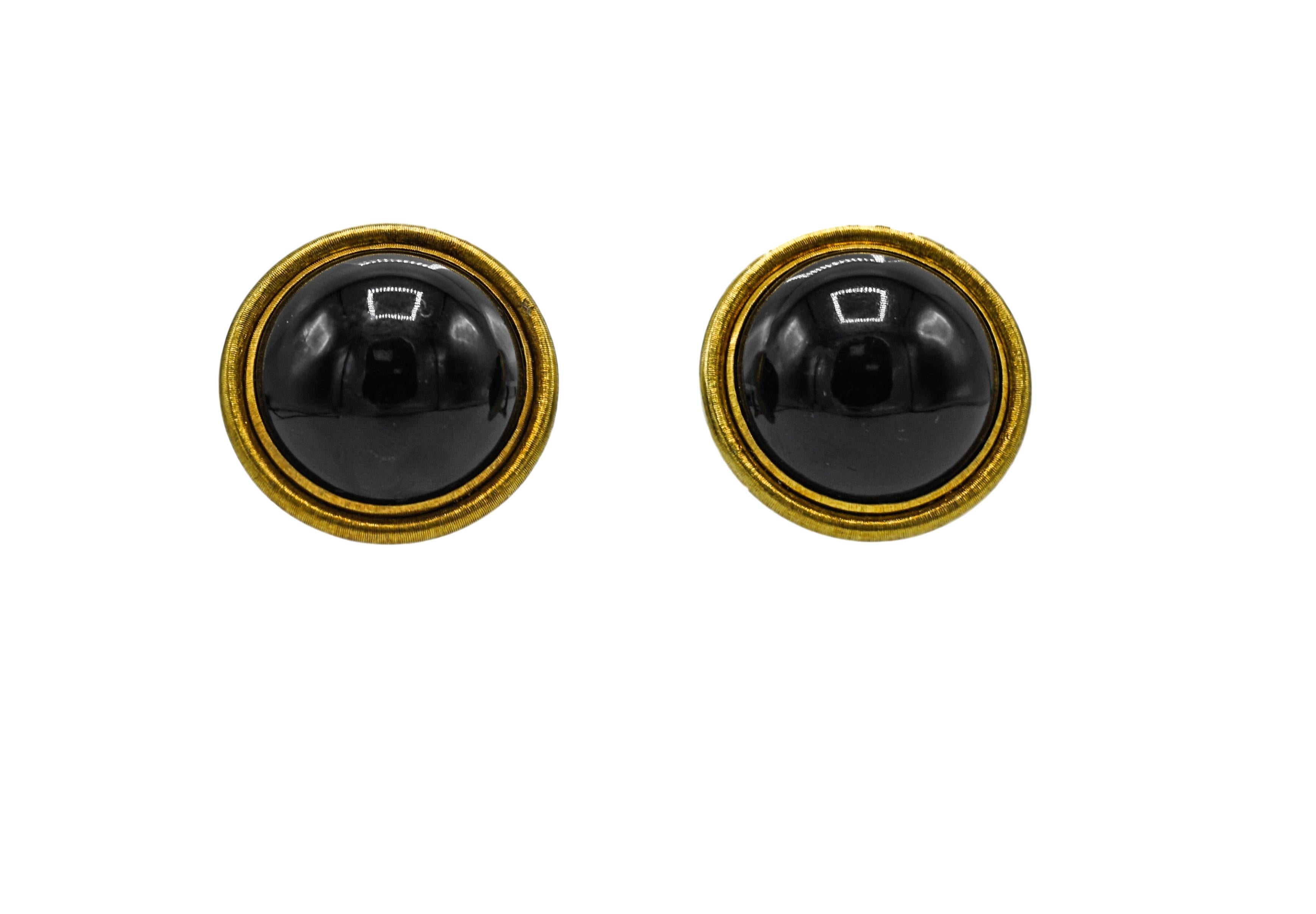 Pair of Gold and Black Onyx Earrings, Buccellati
18 k., 2 round cabochon black onyx ap. 22.0 mm., signed Buccellati, ap. 19 dwts. gross. 
Black onyx , very good luster. 
Warm patina to gold. 
Short posts & clip-backs. Diameters 1 1/16 inches.