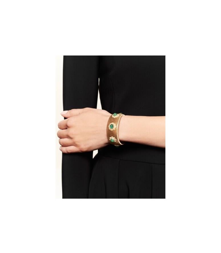 Buccellati Gold and Cabochon Emerald Cuff-Bracelet. Made in Italy, circa 1970.

The brushed gold cuff adorned with gold floral motifs set with emerald cabochons.
Internal circumference 6 inches
Signed Buccellati Italy
Italian assay and registry