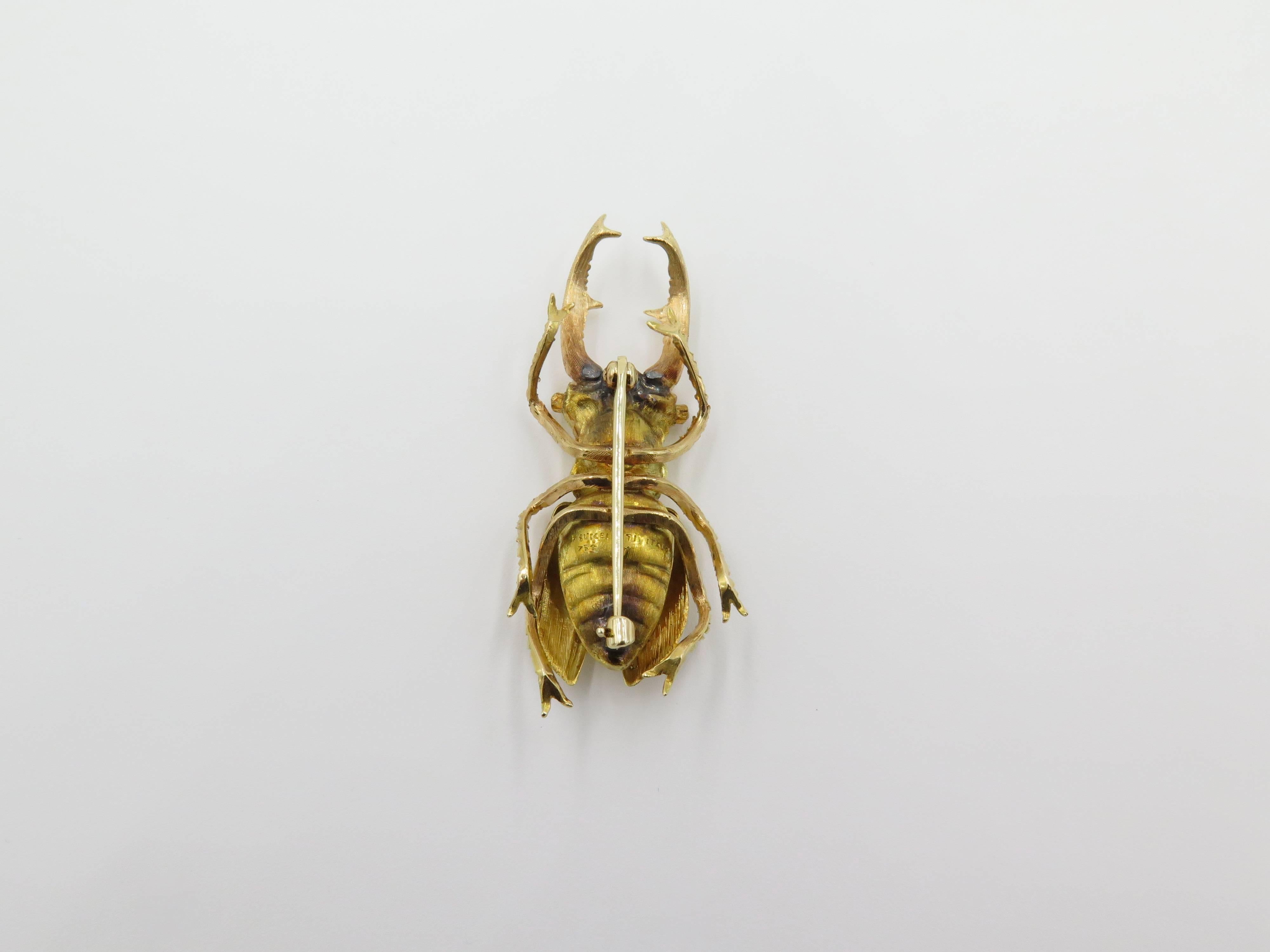 An 18 karat yellow and rose gold beetle brooch. Buccellati. Designed as a Florentine finish beetle. Length is approximately 2 inches. Gross weight is approximately 12.4 grams. 