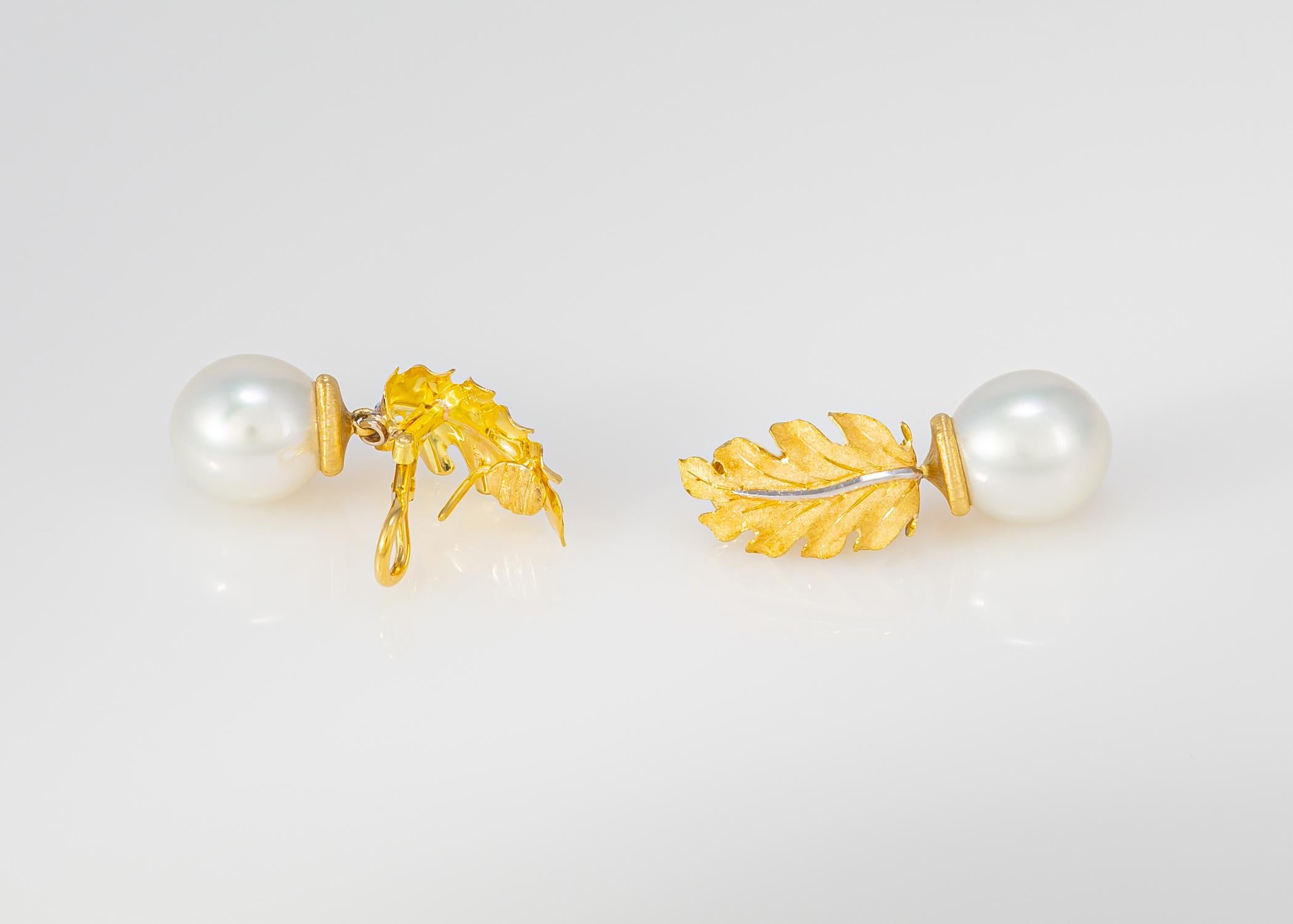 Buccellati's classic leaf motif earrings featuring an exceptional pair of south sea pearls 13.9 x 12.2mm. Just over 1 1/2 inches in length.Classic & Chic.