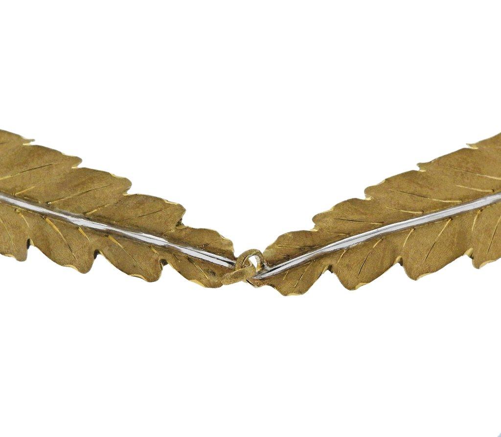 18k gold necklace, crafted by Buccellati, featuring two interlocking leaves. Necklace is 14.5