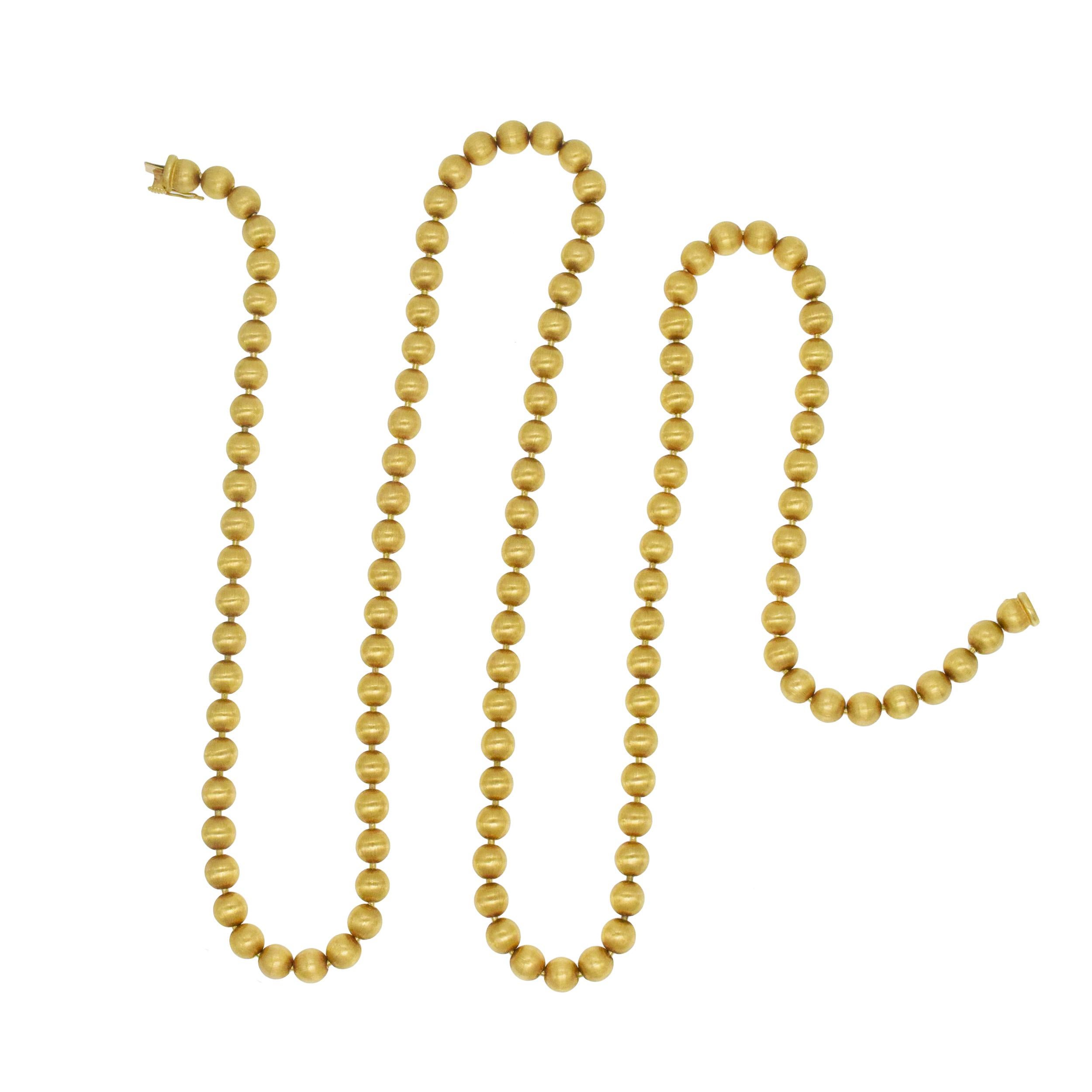 Buccellati 18k Gold Bead Long Necklace. The necklace features 114
gold beads with Buccellati classic brushed finish, equipped with matching design box clasp with fold over safety clasp.
Inscribed: Buccellati, Italy, 18k, Numbered:xxxxx. Bead