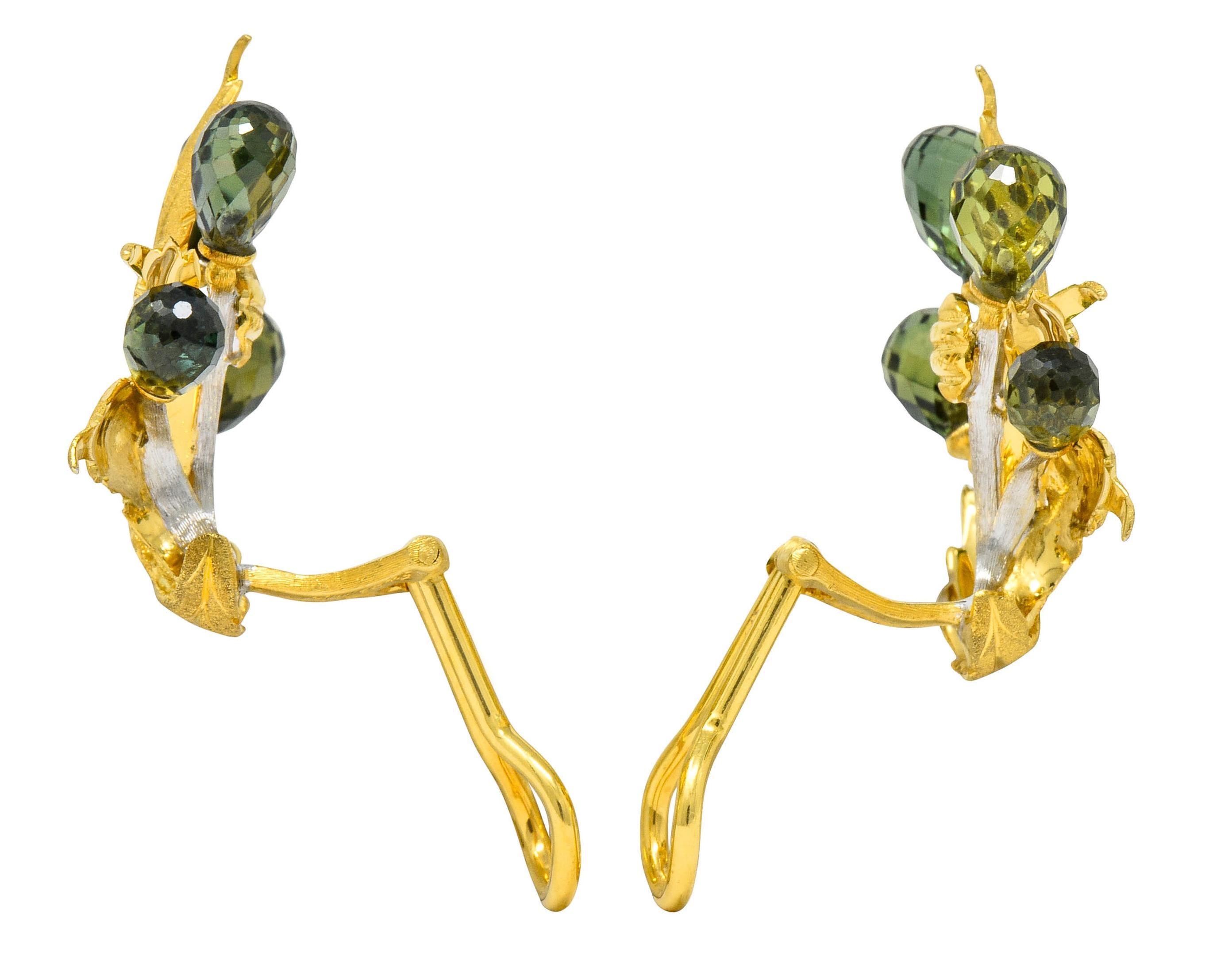 Earrings designed as sprouting foliate leaves featuring a matte gold finish with deeply engraved veining

With white gold vines topped by briolette cut sapphire, transparent medium-dark bluish-green to medium-light yellowish-green

Completed by