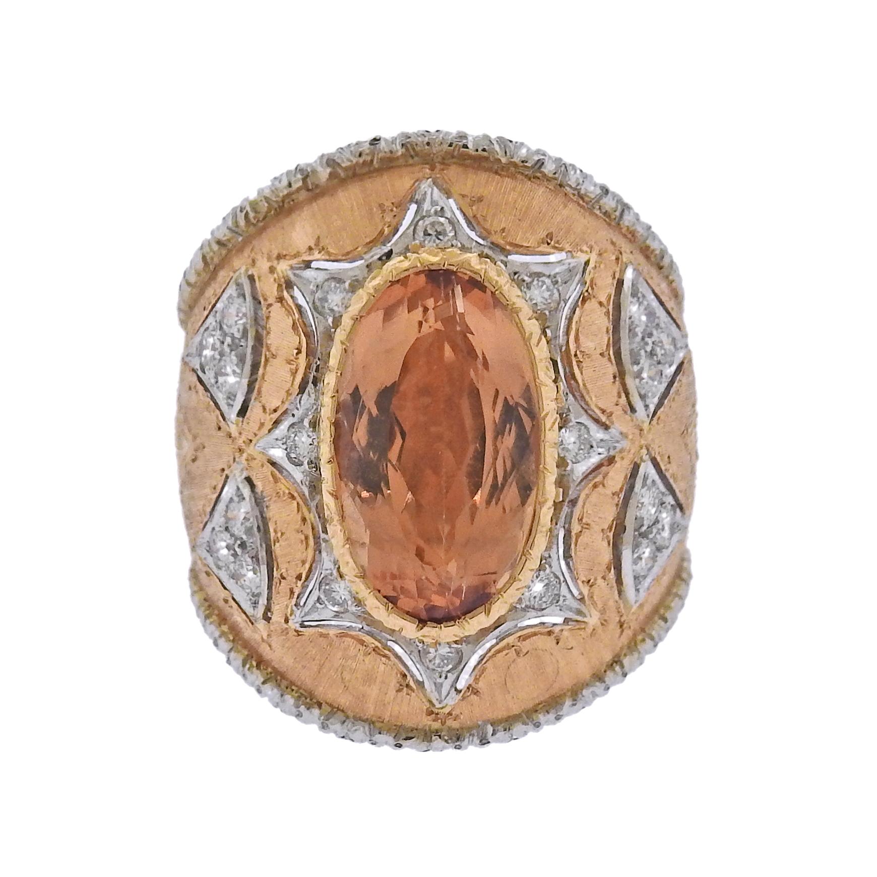 Impressive 18k rose and yellow gold dome ring, crafted by Mario Buccellati , decorated with approx. 8.5 - 9ct padparadscha topaz as a centerpiece, surrounded with approx. 0.44ctw in G/VS diamonds. Ring is a size 6 3/4, ring top is 24mm wide. Marked