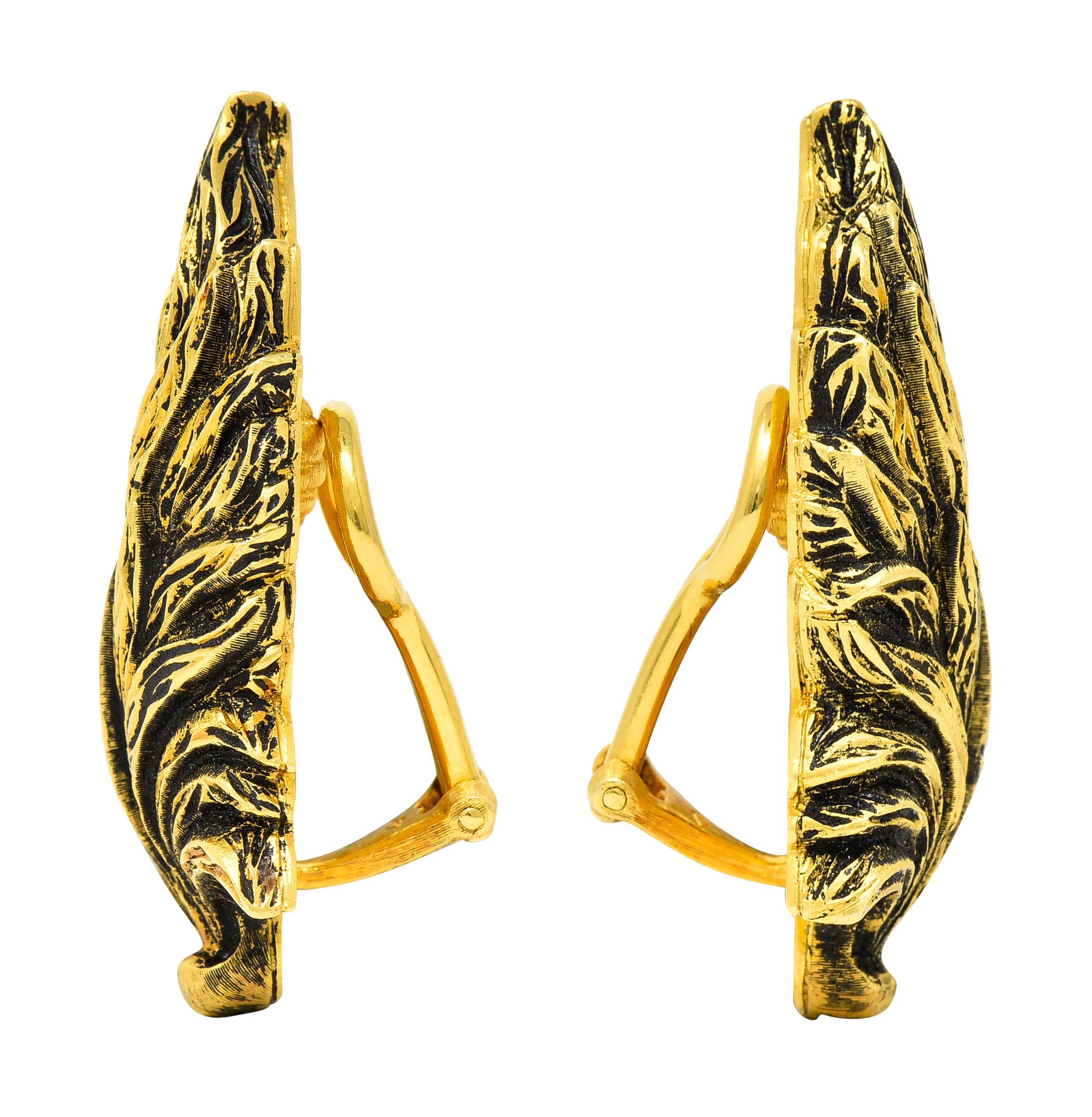Lightweight puffed gold forms are highly texturous and rendered as feathers. With a high contrasting oxidized finish accentuating details. Completed by hinged omega backs. Inscribed K18 for 18 karat gold. Numbered and fully signed Buccellati Italy.