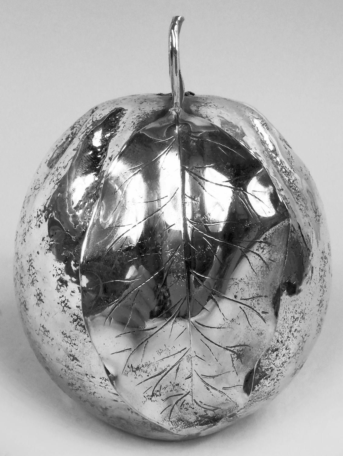 Italian Modern sterling silver figural fruit orange lighter. Ovoid with furrowed and irregular skin and leafing stem. Underside inset with detachable lighter. Marked “Buccellati / Italy / Sterling”.  Weight (without lighter): 6.3 troy ounces. 