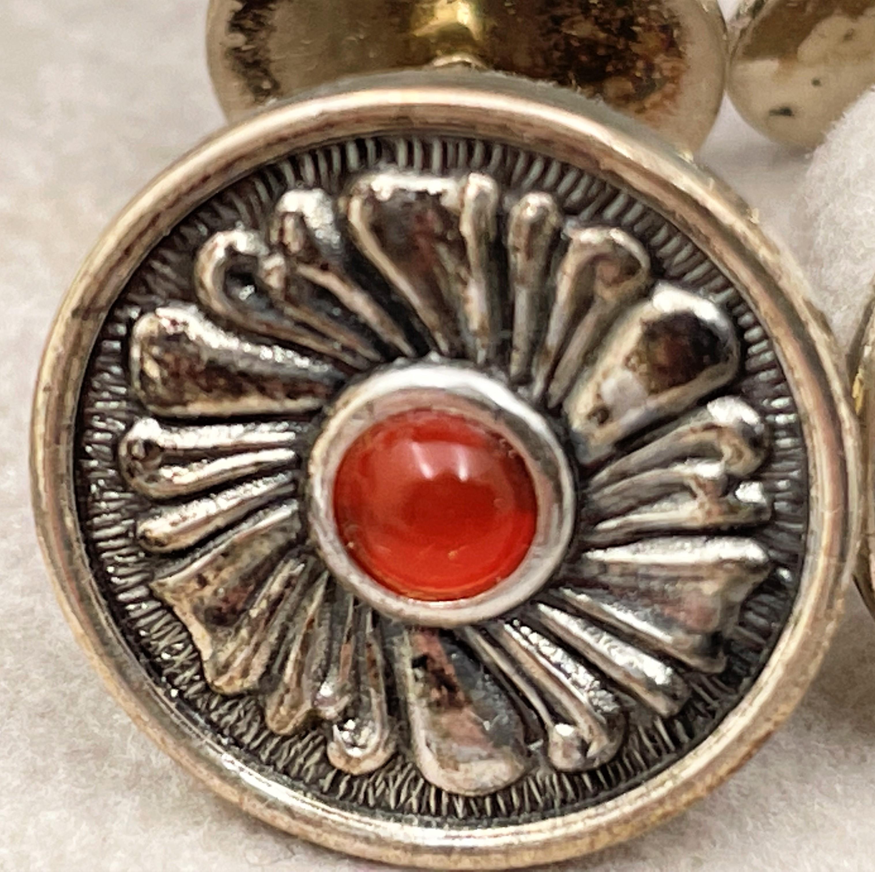 Gianmaria Buccellati, Italian, pair of sterling silver cufflinks, with a red stone at the center, in a beautiful floral motif, measuring 2/3'' in diameter, and bearing hallmarks. Sold in its original box, never used.

Mario Buccellati, the founder