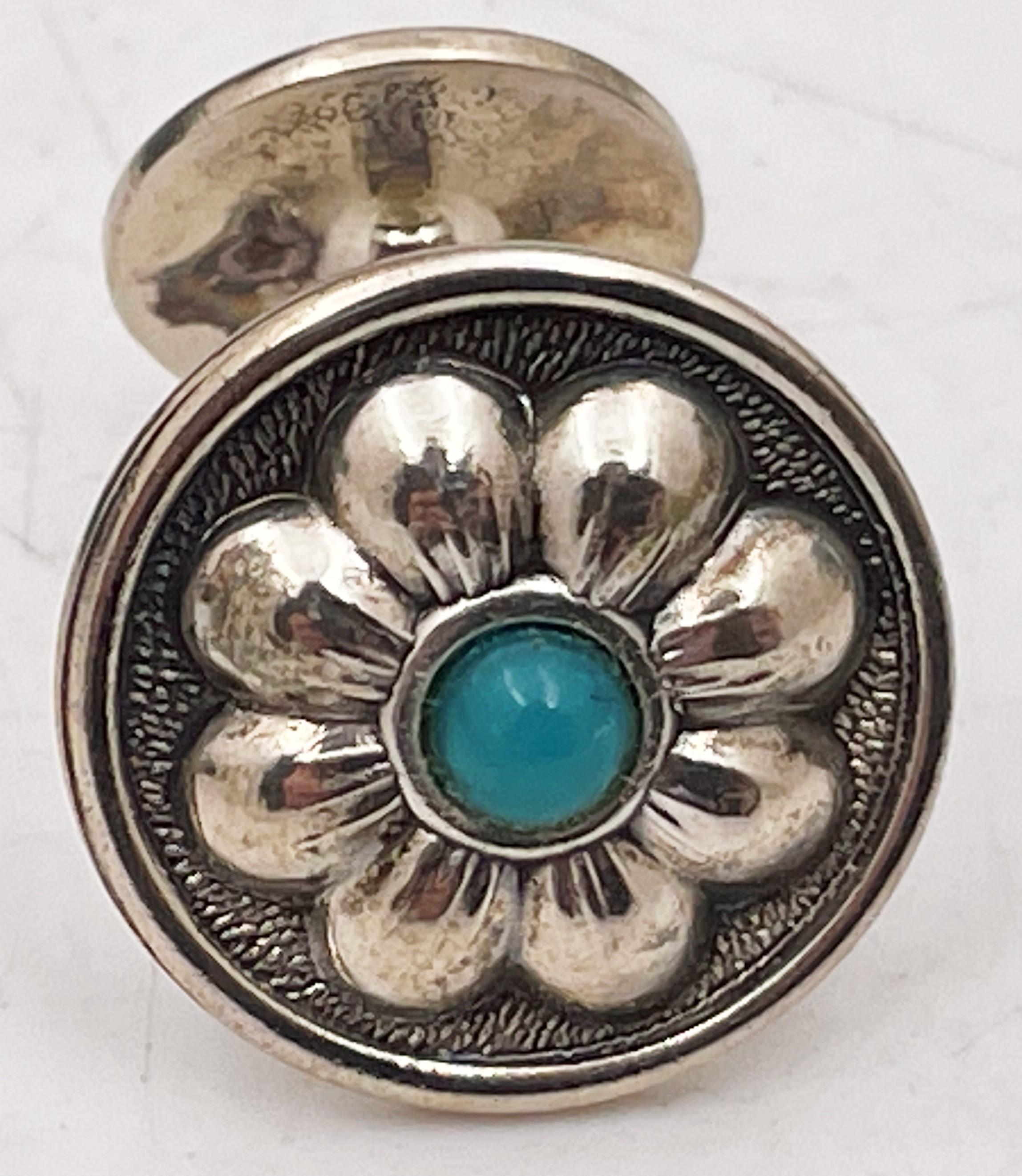 Gianmaria Buccellati, Italian, pair of sterling silver cufflinks with turquoise at the center, in a beautiful floral motif, measuring 2/3'' in diameter, and bearing hallmarks. Sold in its original box, never used. 

Mario Buccellati, the founder