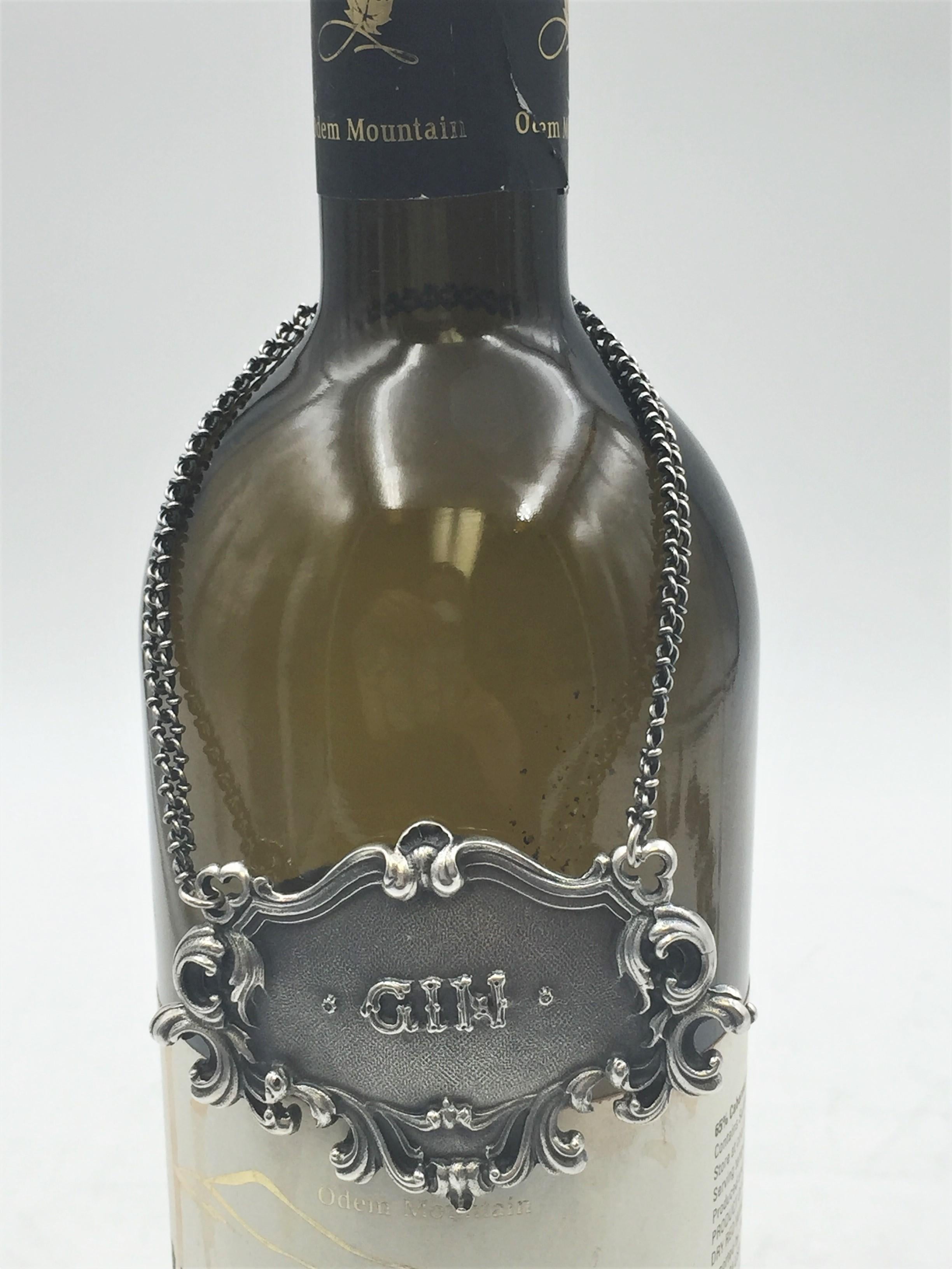 Rare Buccellati sterling silver claret bar jug label. GIN embossed on the front in the center.

Marks on the back: Gianmaria Buccellati (signature and Italian maker's mark), ITALY, 925 (encircled silver purity mark).

It measures 2.5in x 1.75in.