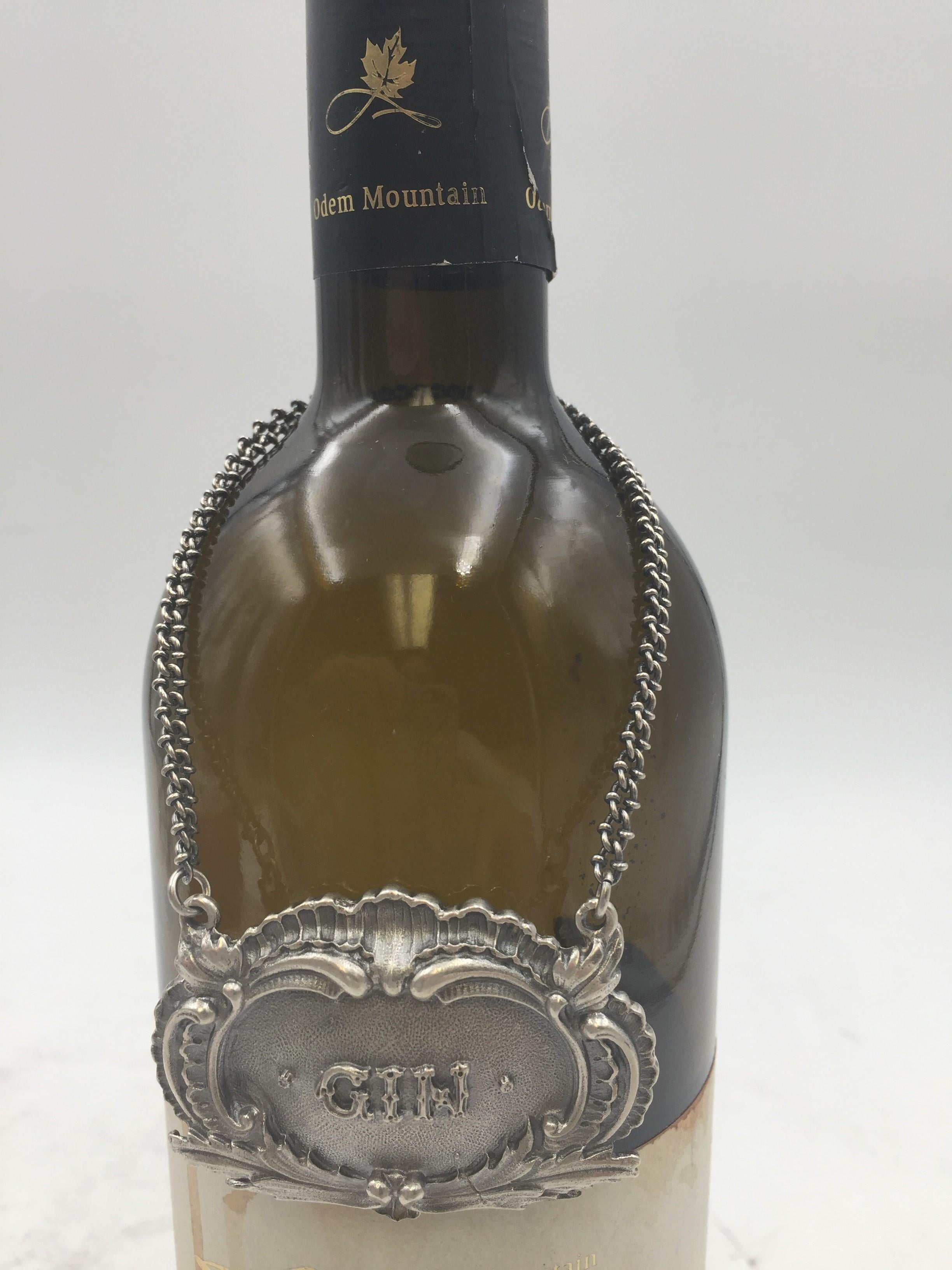 Rare Buccellati sterling silver claret jug bar label. GIN embossed on the front in the center.

Marks on the back: Gianmaria Buccellati (signature and Italian maker's mark), ITALY, 925 (encircled silver purity mark).

Dimensions: 2.25 in x 1.5 in.