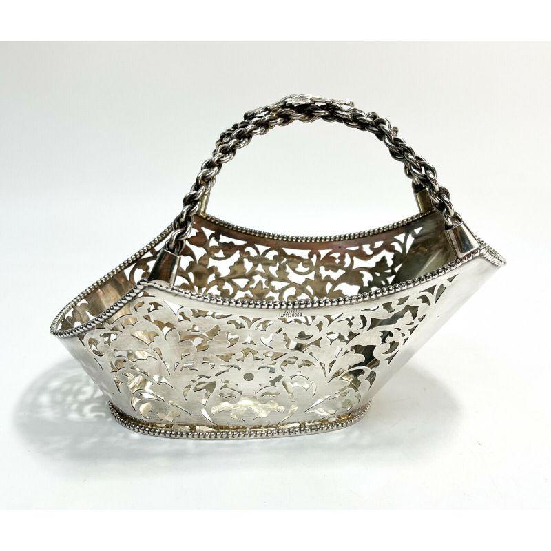 Buccellati Italian sterling silver pierced wine caddy with beaded rim

Buccellati Italian sterling silver pierced wine caddy. Pierced leaves to the walls with a beaded rim. Chained handle with a grape leaf center. Buccellati sterling silver marks