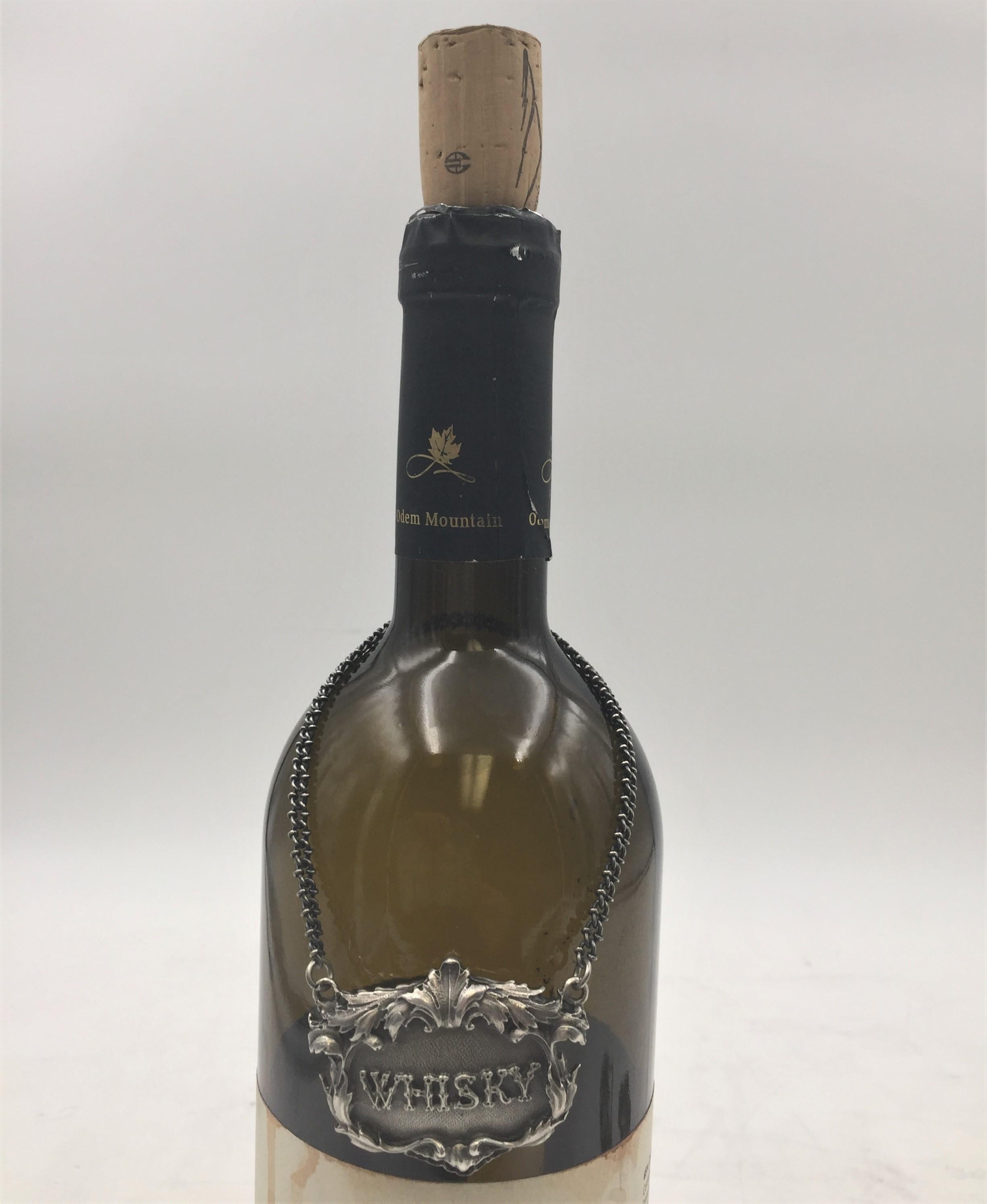 Rare 925 sterling silver claret jug label. WHISKY embossed on the front in the center.

Marks on the back: Gianmaria Buccellati (signature and Italian maker's mark), ITALY, 925 (encircled silver purity). 

Dimensions: 1.5in x 1.5in. Weight: 1 oz