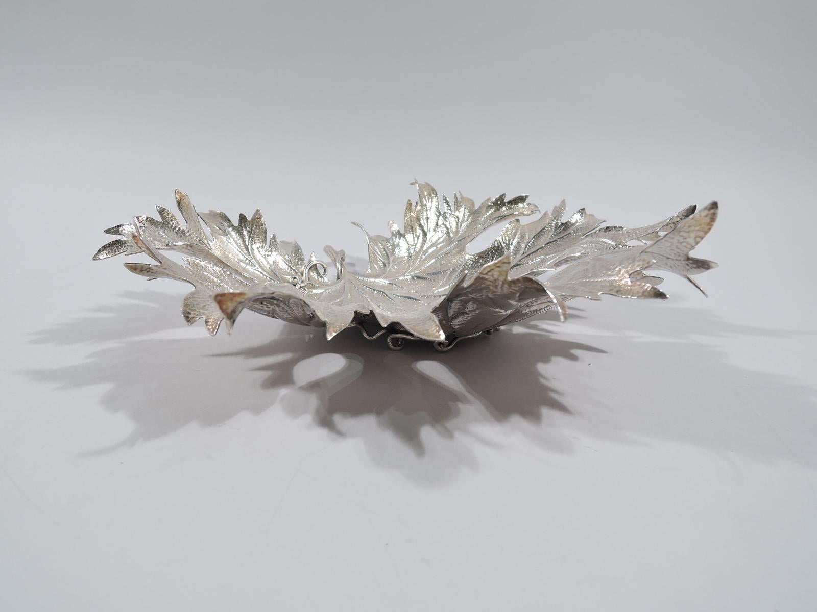 Large sterling silver figural dish. Realistic maple leaf with stippled irregularities, chased veins, curling and serrated tips, tendril-entwined wood stem, and tendril support. Marked “Buccellati Italy Sterling”, post-1967 Italian mark for Pradella