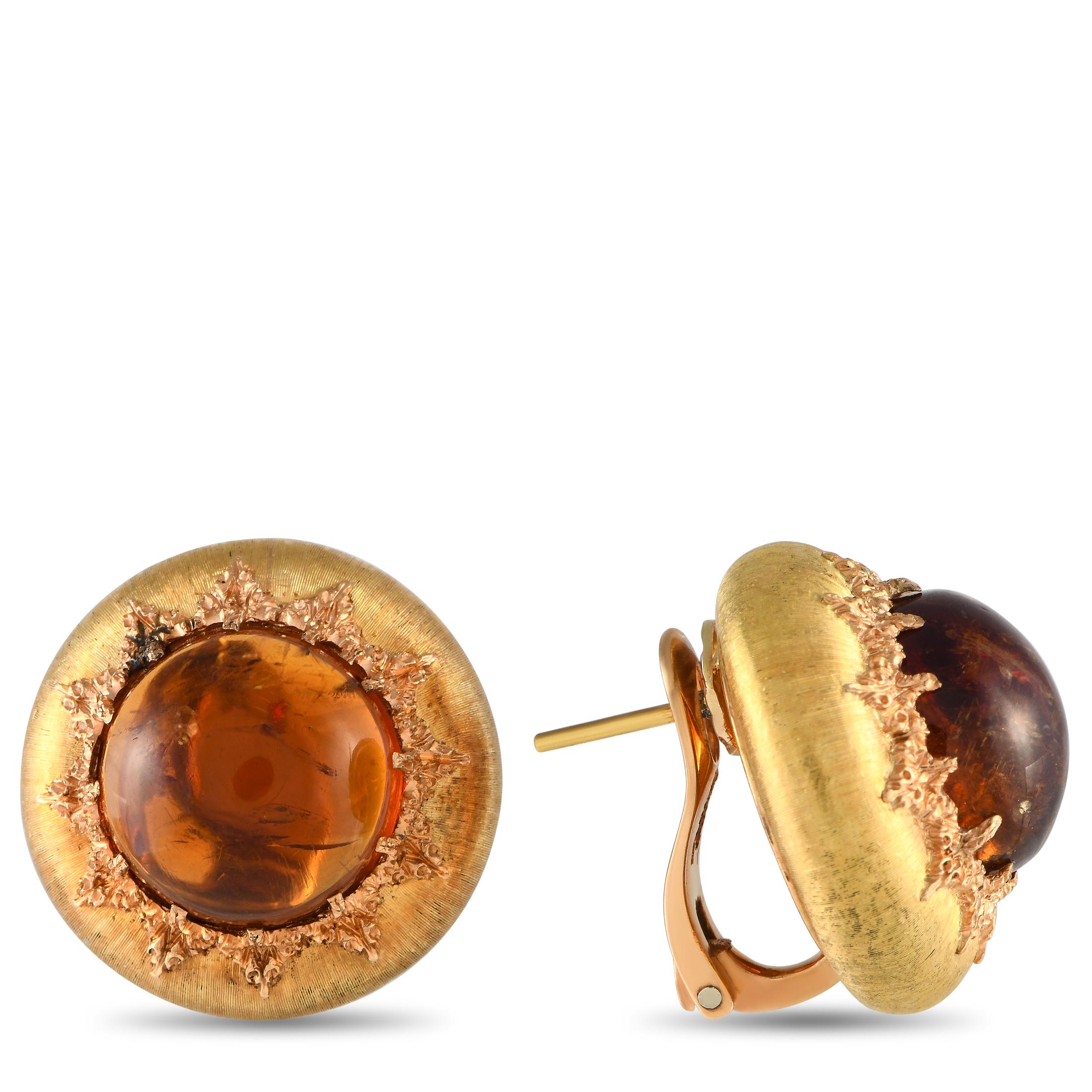 Give your outfits a gorgeous amber glow by incorporating this pair of Buccellati earrings. Each earring features a rich and vibrant amber stone nestled within a round and textured yellow gold frame. Handmade engraving in leaf motif surrounds the