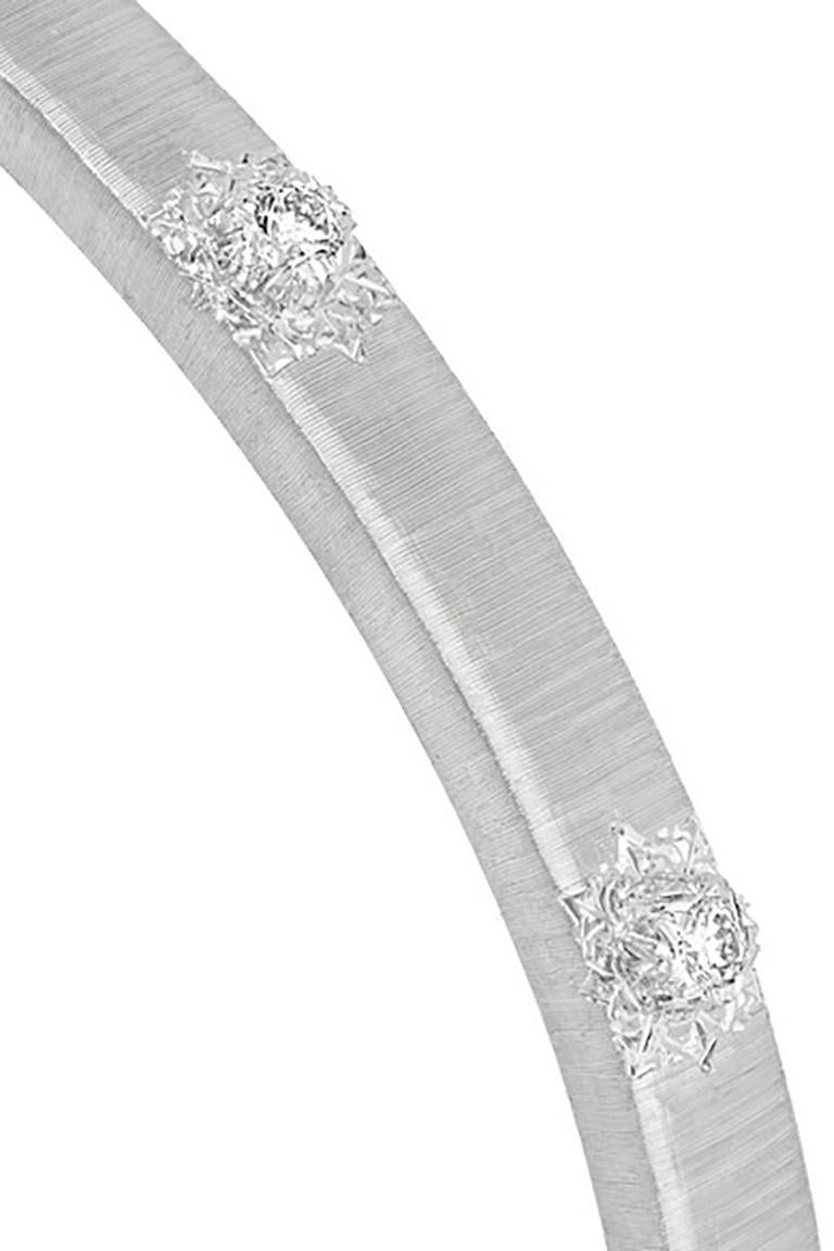 Buccellati's 'Macri Classica Bracelet' features an open cuff silhouette in textured white gold with 10 brilliant-cut diamonds set in small star-shaped rosettes.

This 5 mm wide cuff bracelet is made in 18 karat white gold and engraved using the