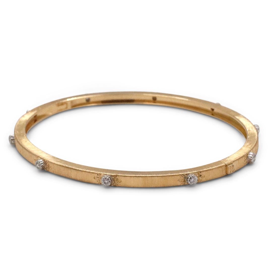 Authentic Buccellati 'Macri Classica' bracelet crafted in 18 karat yellow gold.  The classic Buccellati bracelet features a Florentine finish and is set with 10 round brilliant diamonds weighing an estimated .10 carats total.  The bracelet measures