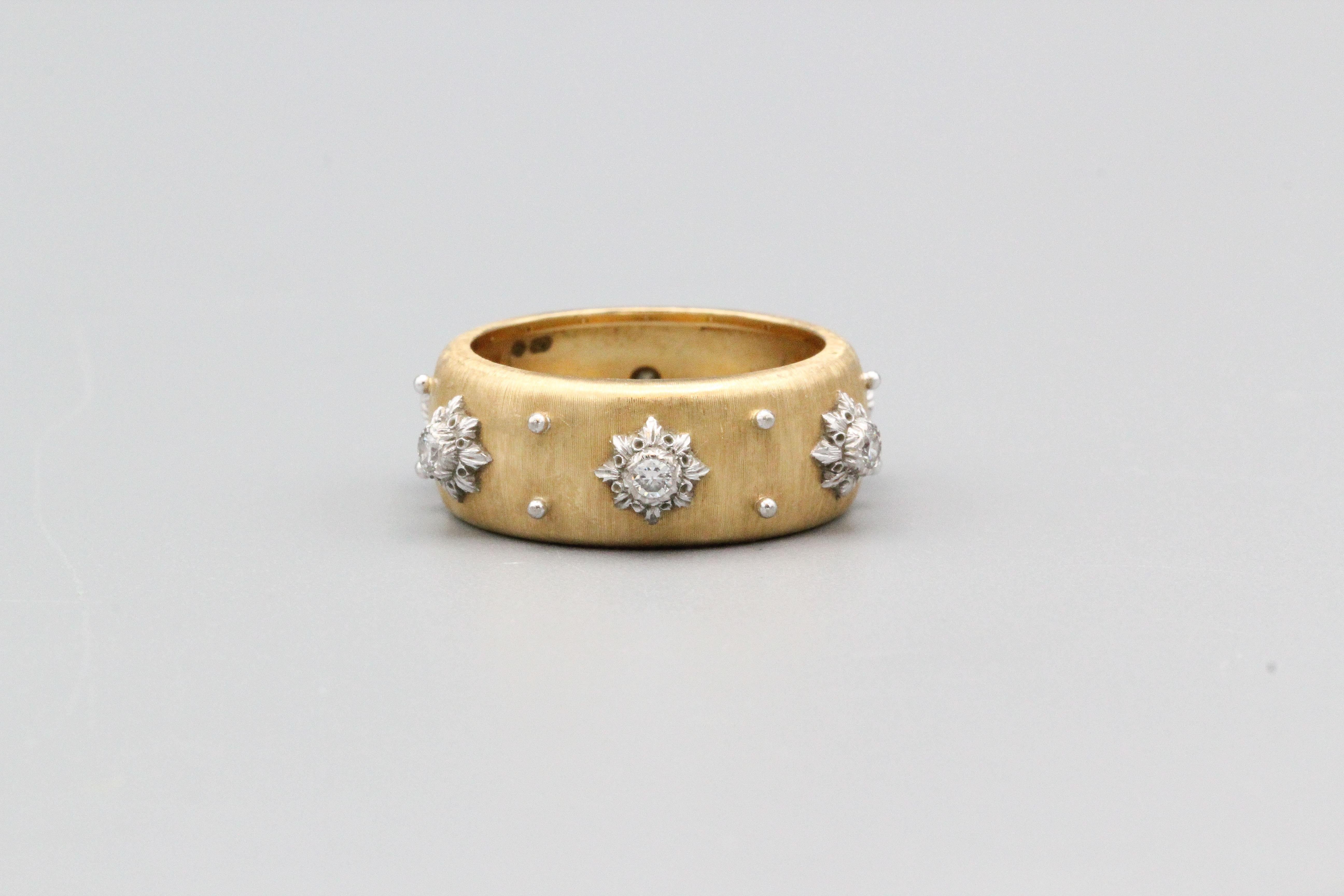 Fine 18K yellow and white gold diamond band ring from the Macri collection by Buccellati. It features the rigato motif, a florentine finish hand made and designed to bring out a different perspective on gold.  Set with high grade round brilliant cut